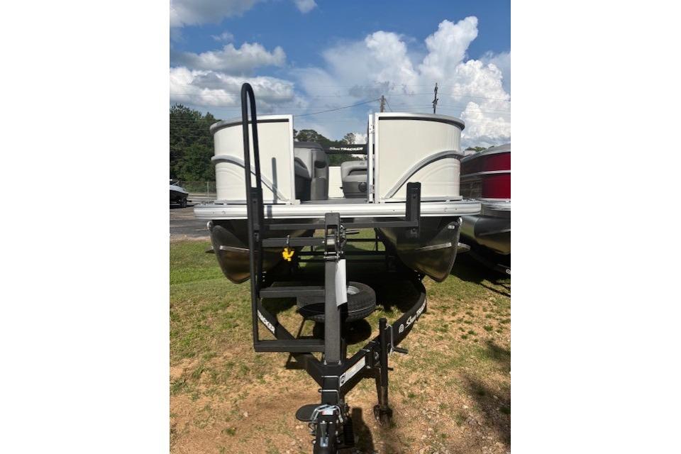 2026 Sun Tracker Party Barge 18 DLX pontoon boat on trailer, parked on grass.