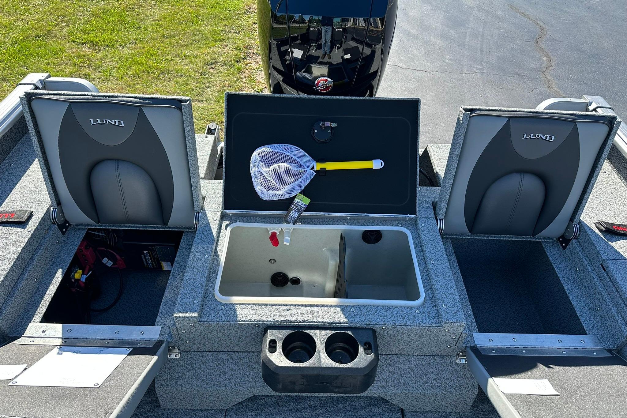 2026 Lund 1875 Impact XS Sport boat interior with storage compartments and seating.