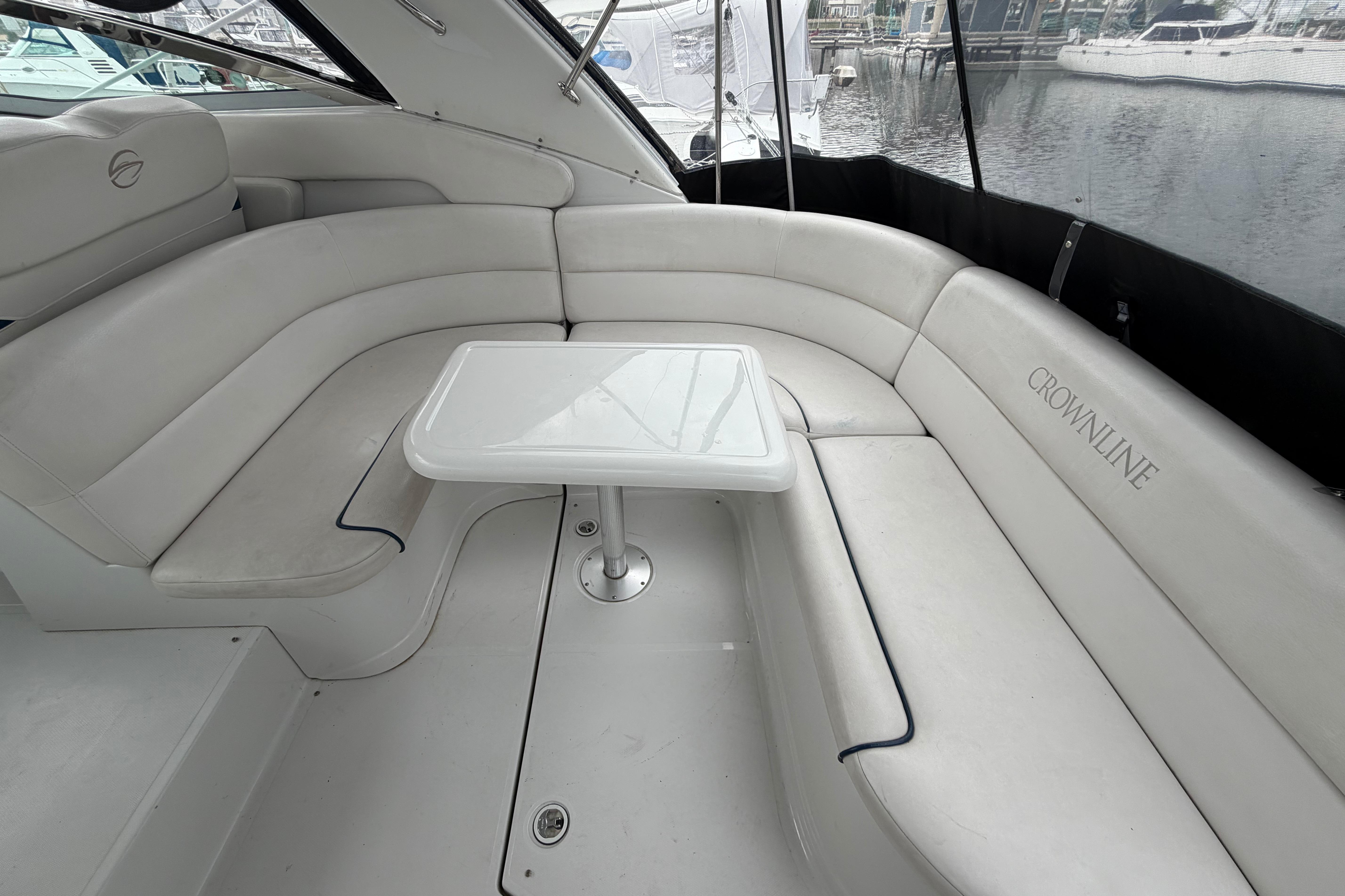 Luxurious seating area on a 2008 Crownline 340 CR yacht with a sleek white interior.