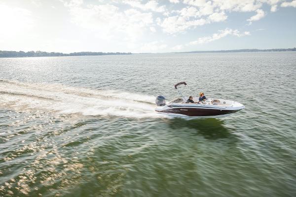 2025 Hurricane SunDeck Sport 205 OB cruising on a sunny lake.