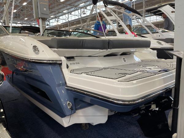 2025 Monterey 218 SS boat displayed indoors, showcasing sleek design and modern features.