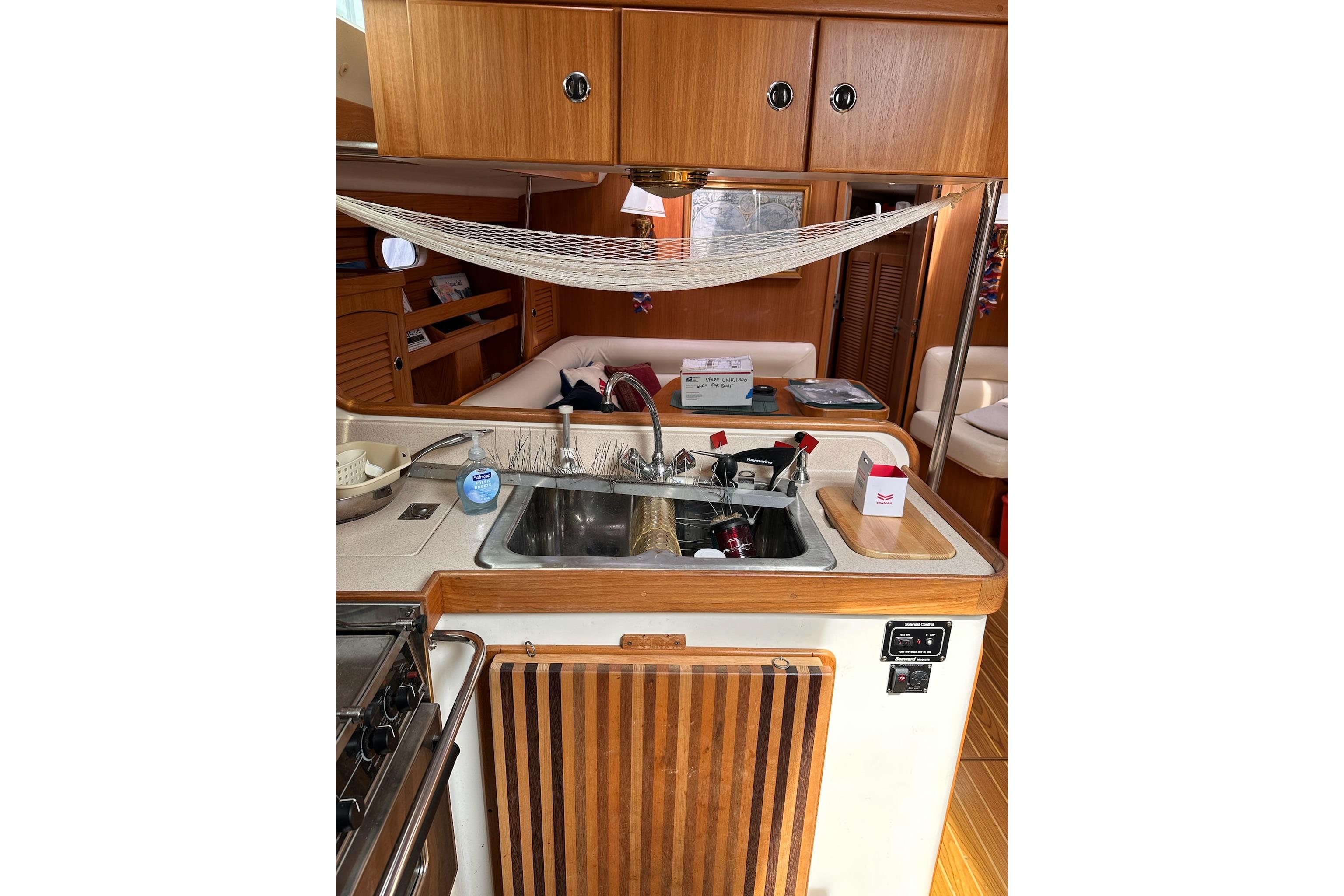 Interior of 2002 Catalina 470 yacht featuring a compact kitchen area.