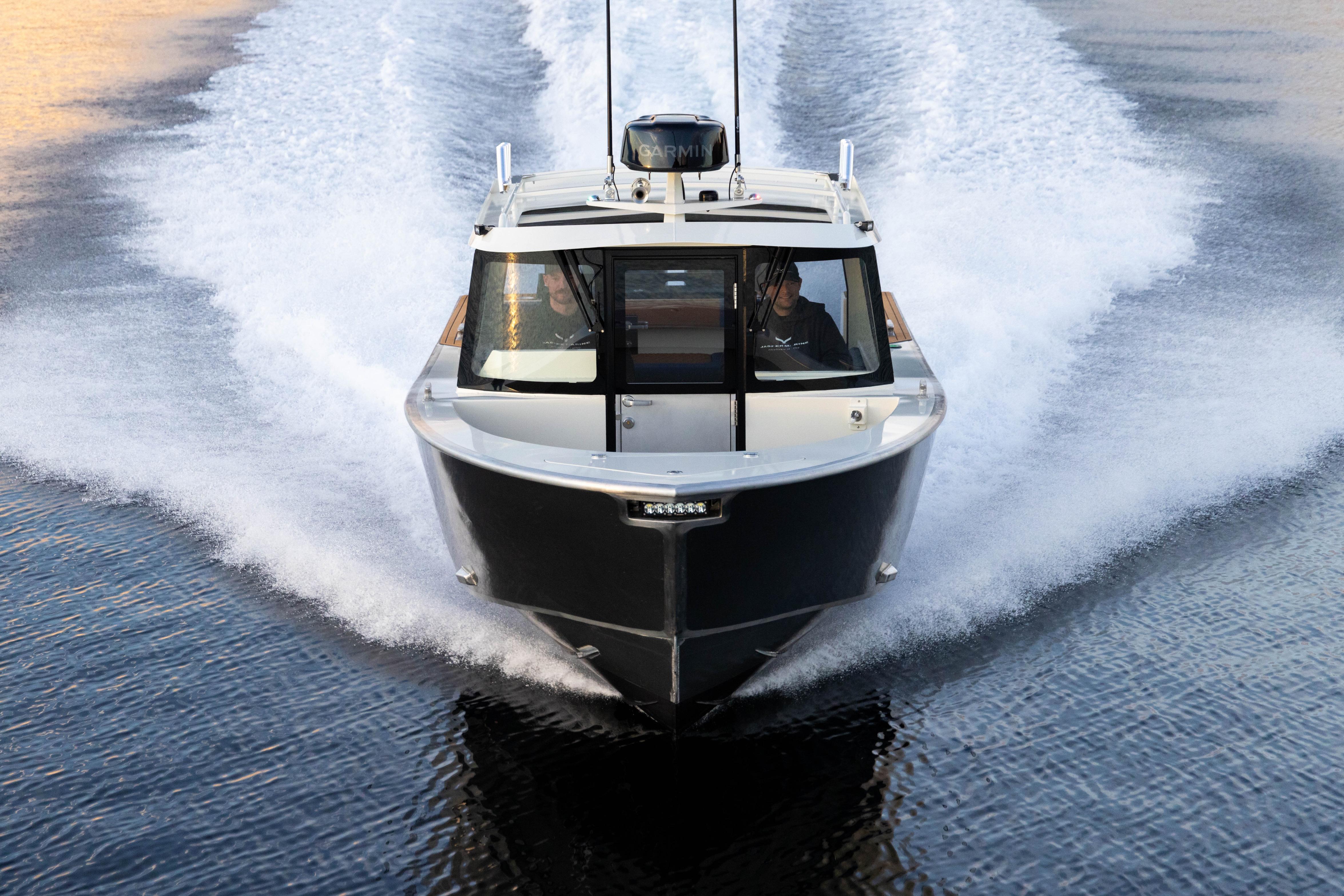 2026 Jasper Marine Defender 22 cruising on water, creating dynamic wake.