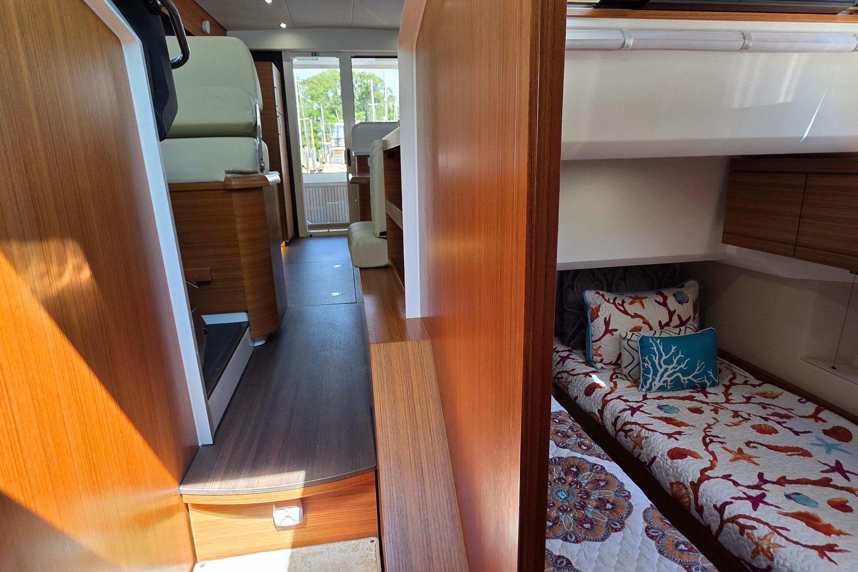 Interior of 2023 Greenline 40 yacht with cozy cabin and vibrant bedding.