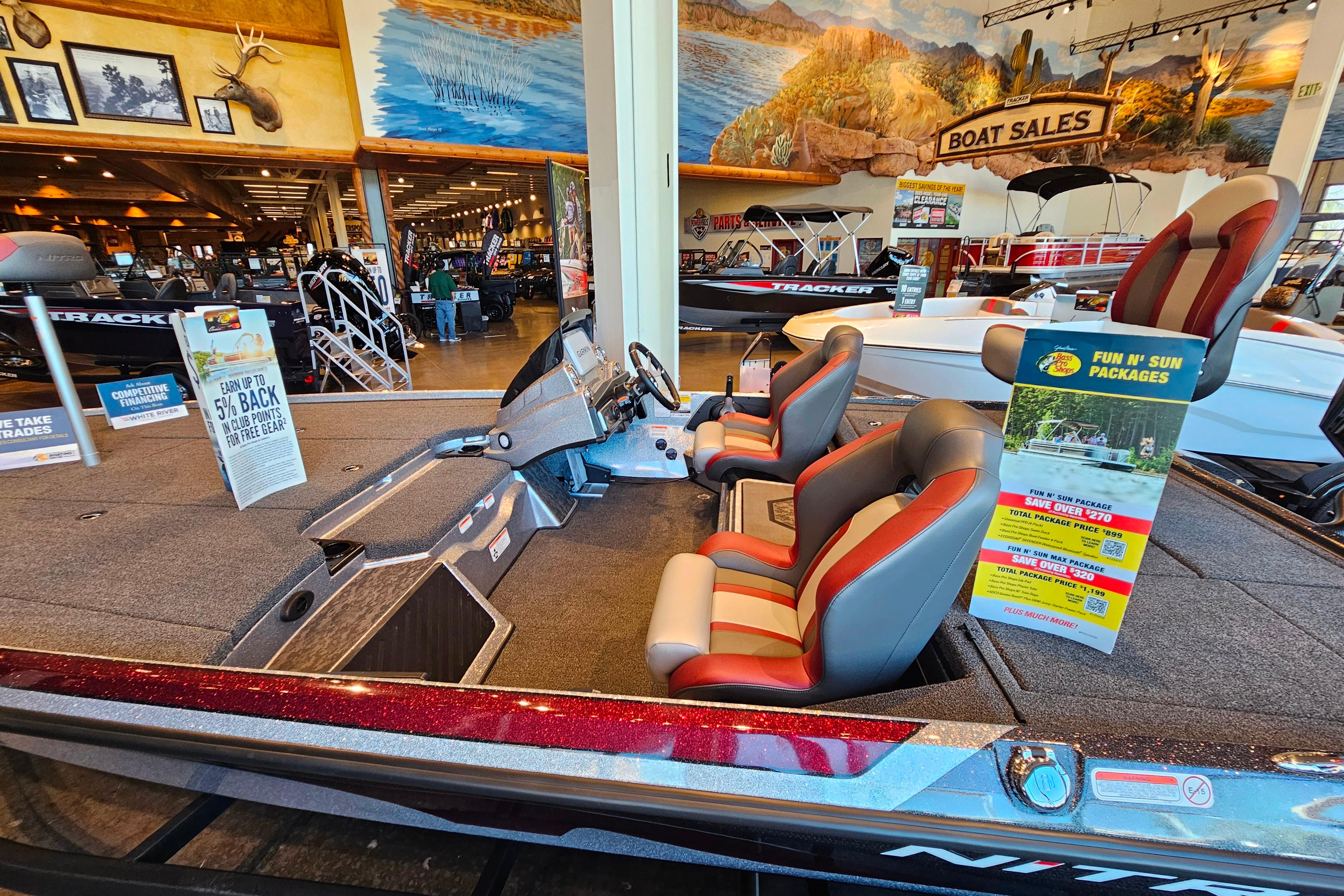 2025 Nitro Z20 XL Pro boat on display in showroom with promotional signage.