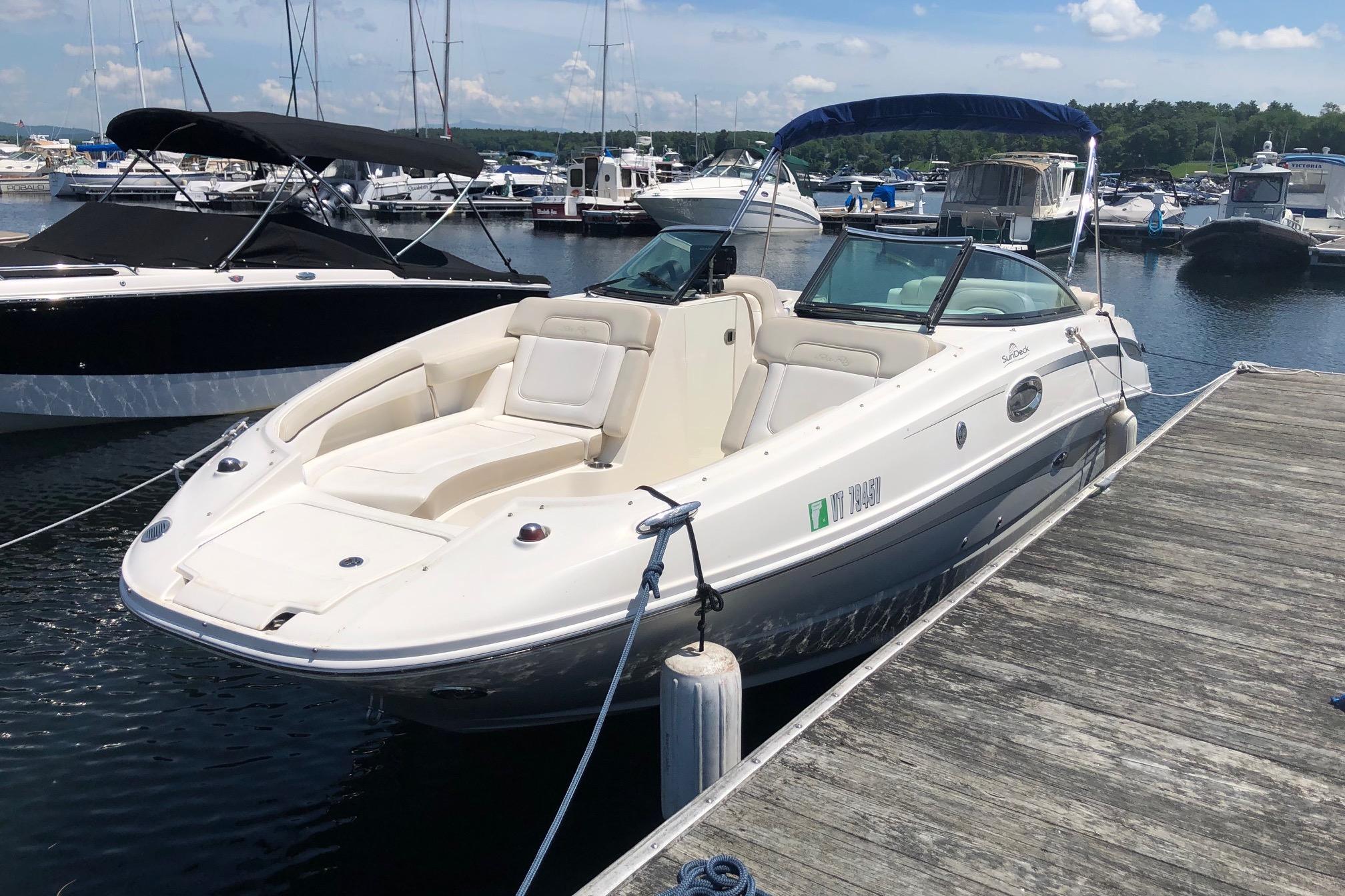 2013 Sea Ray 260 Sundeck boat docked at a marina on a sunny day.