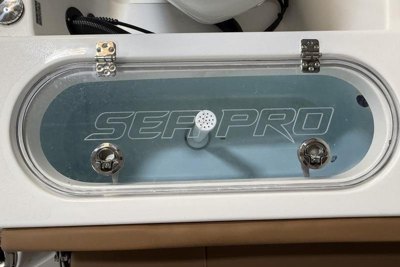 Livewell of 2026 Sea Pro 242 Center Console boat with clear lid and branding.