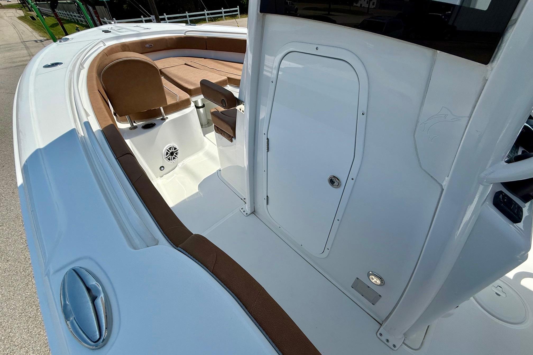 2026 Sea Hunt Ultra 305 SE boat interior with seating and storage compartment.
