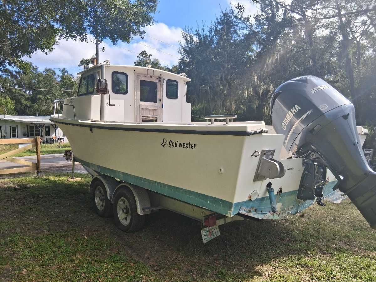 1987 Parker Sou'wester boat on trailer outdoors.