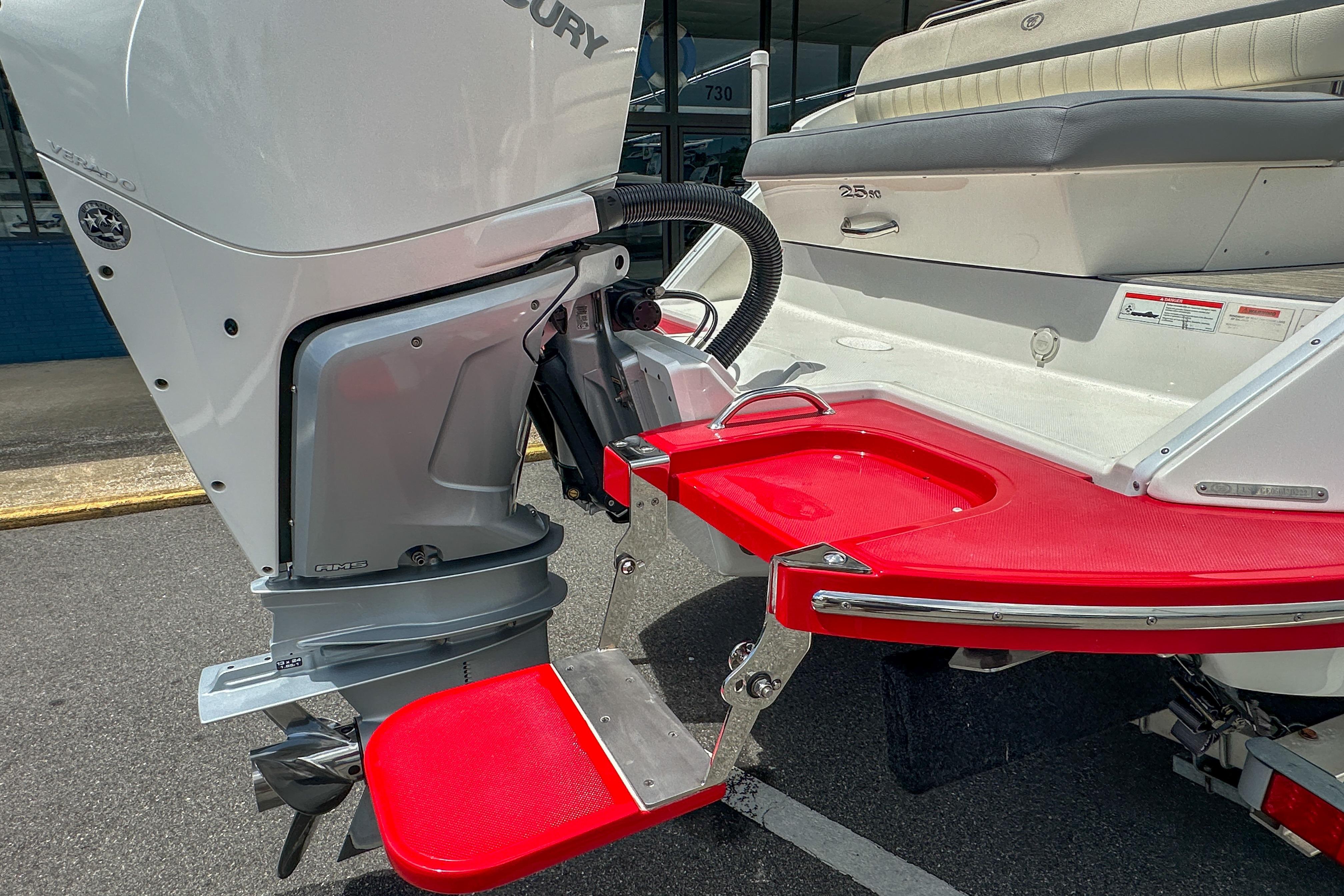 2022 Cobalt 25SC boat with Mercury outboard motor and red swim platform.