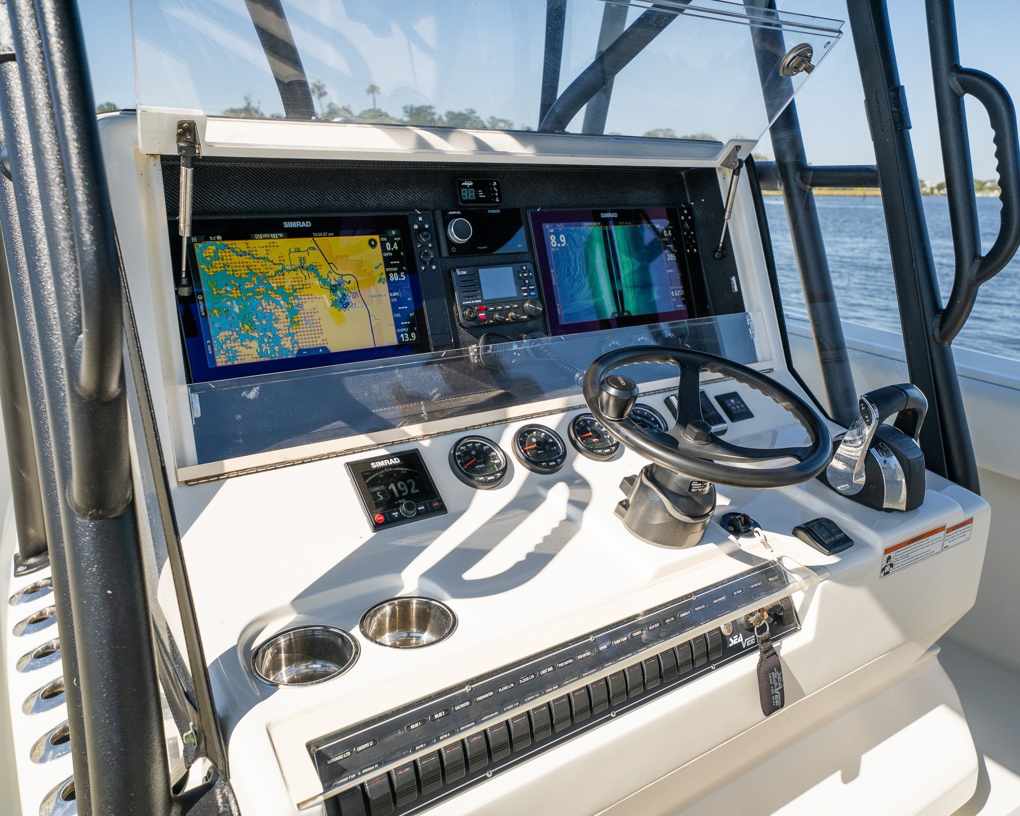 The image shows the helm of a SeaVee 370Z boat with modern navigation systems.