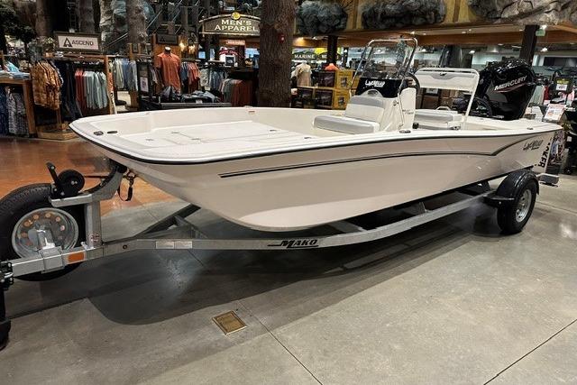 2026 Mako Pro Skiff 17 CC boat on display in a showroom with trailer.