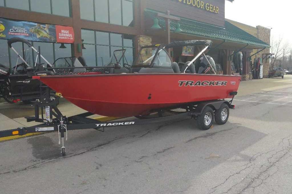 2026 Tracker Targa V-18 WT boat on trailer outside outdoor gear store.