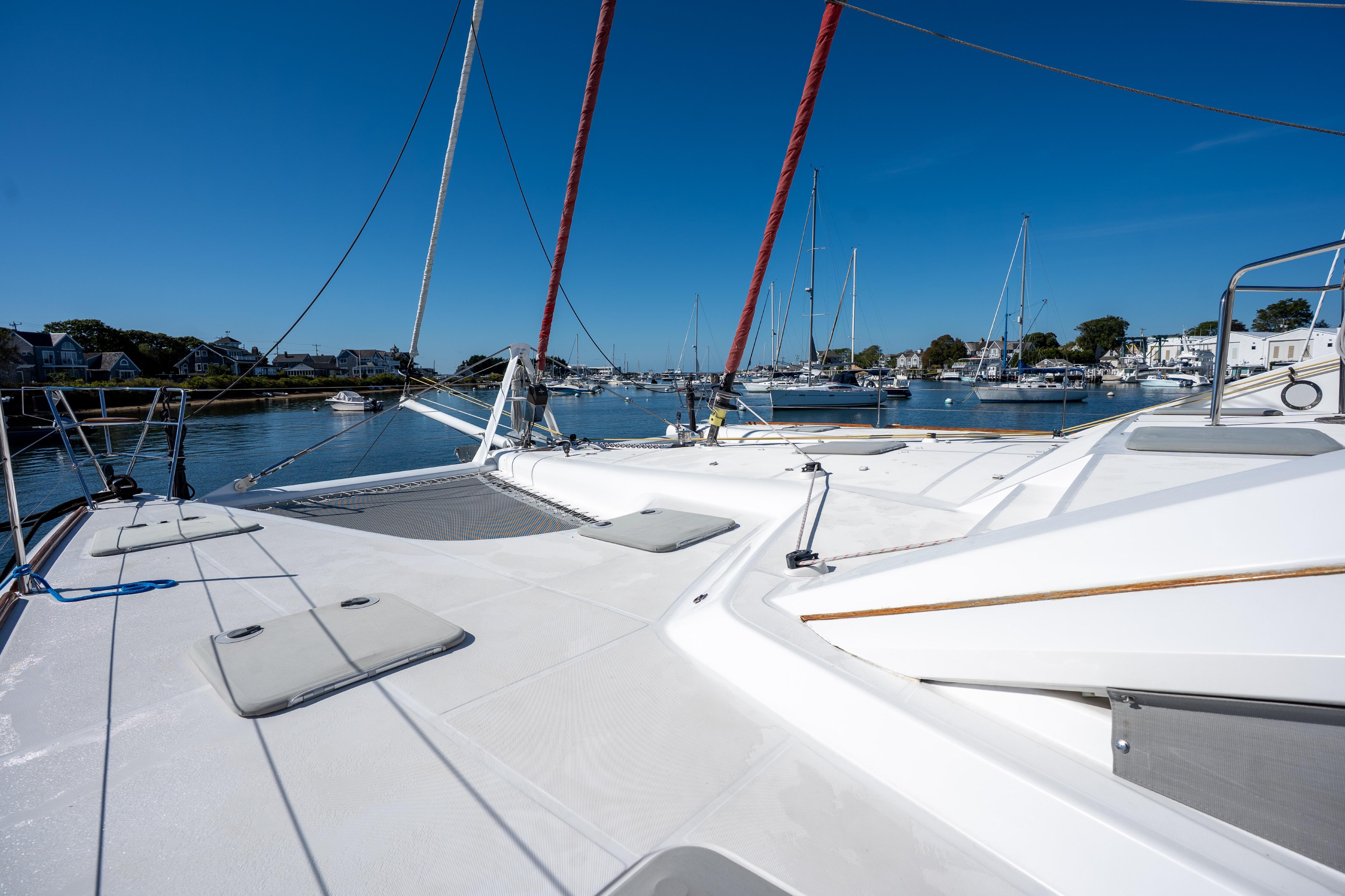 2009 Privilege 615 yacht docked in a serene marina under clear blue skies.