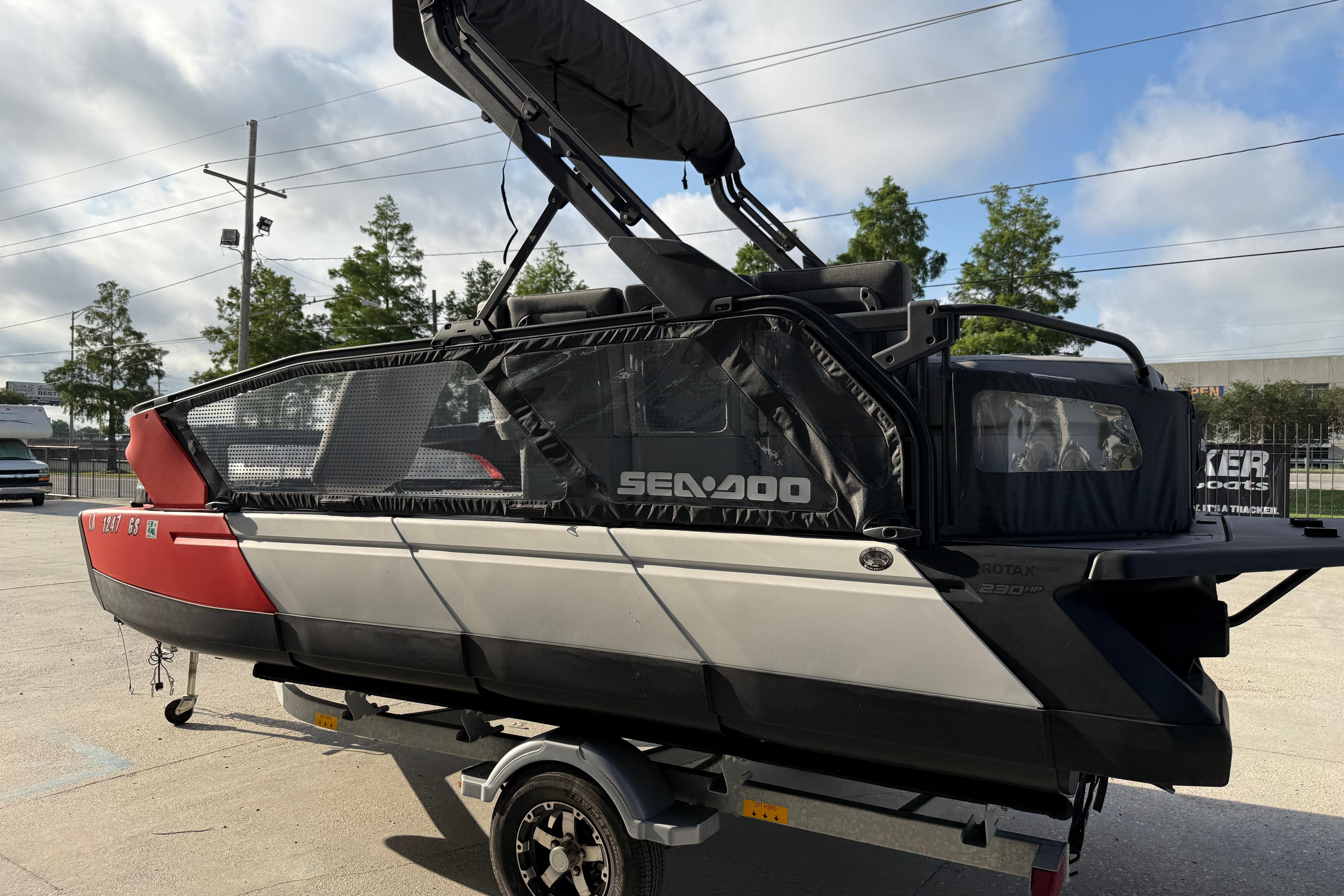 2023 Sea-Doo Switch Sport 18 pontoon boat on trailer, parked outdoors.
