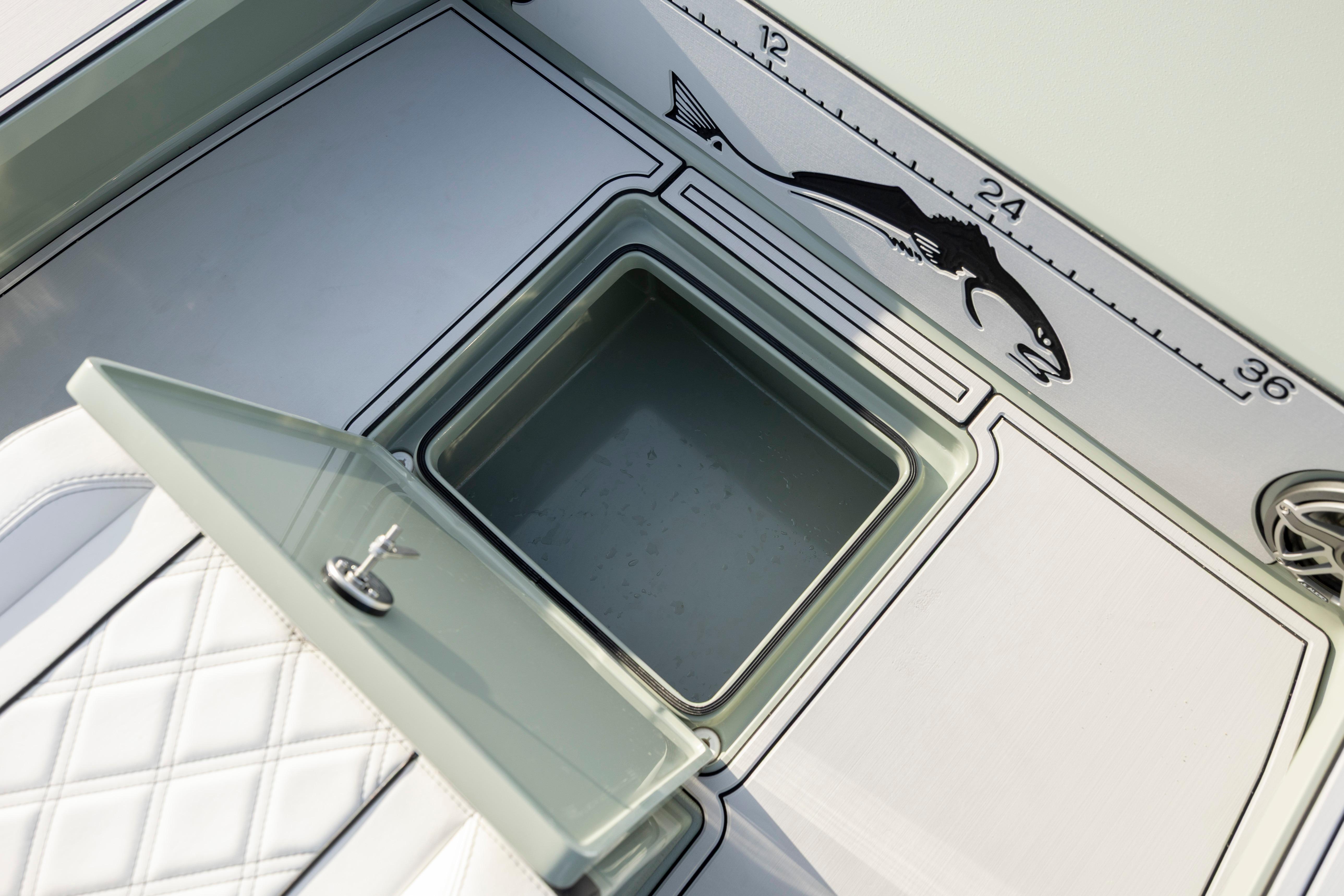 Open storage compartment on Vtech 18 boat, featuring fish measurement scale, 2025 model.