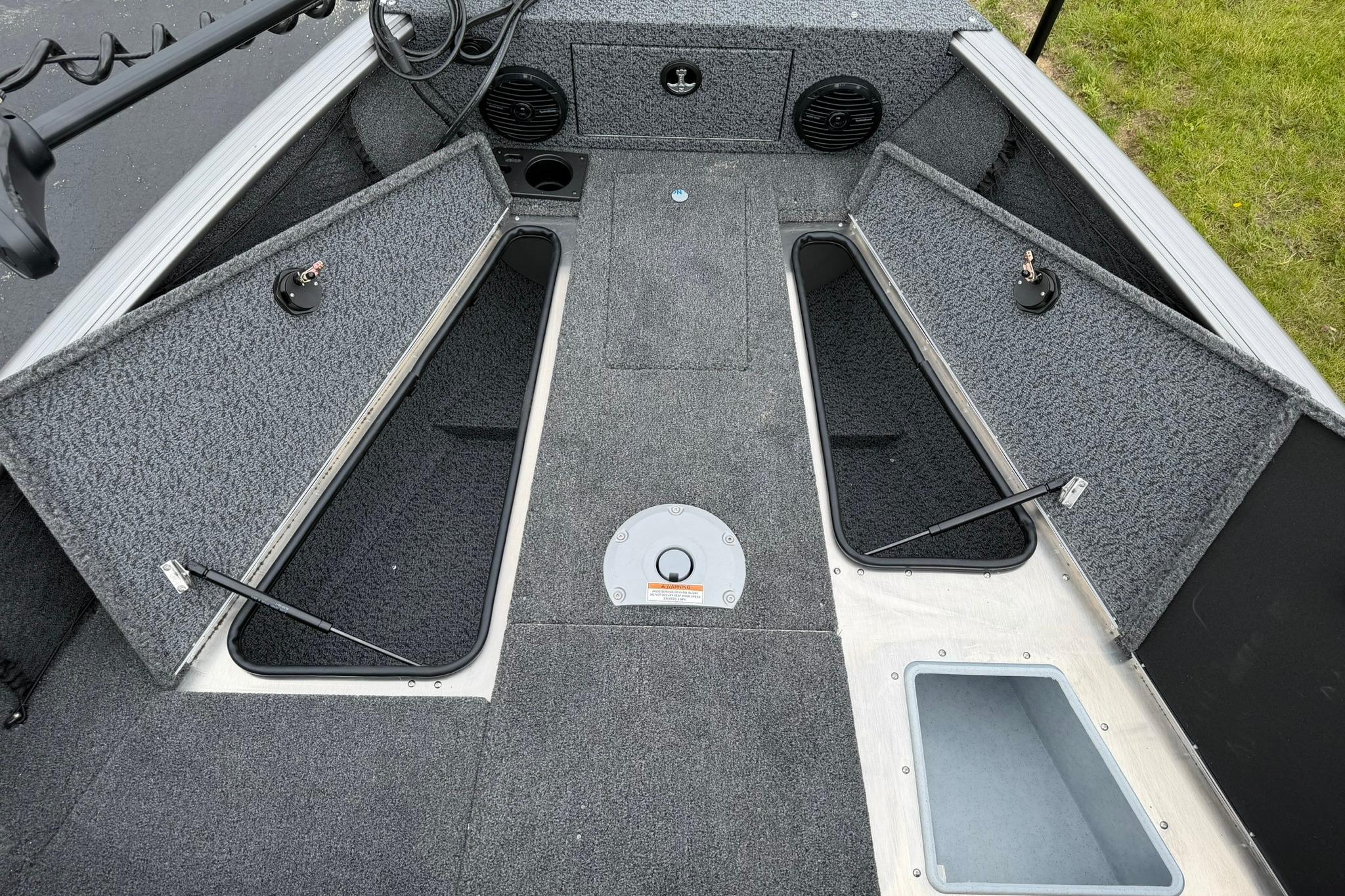 2027 Lund 1875 Impact XS Sport boat interior with open storage compartments.