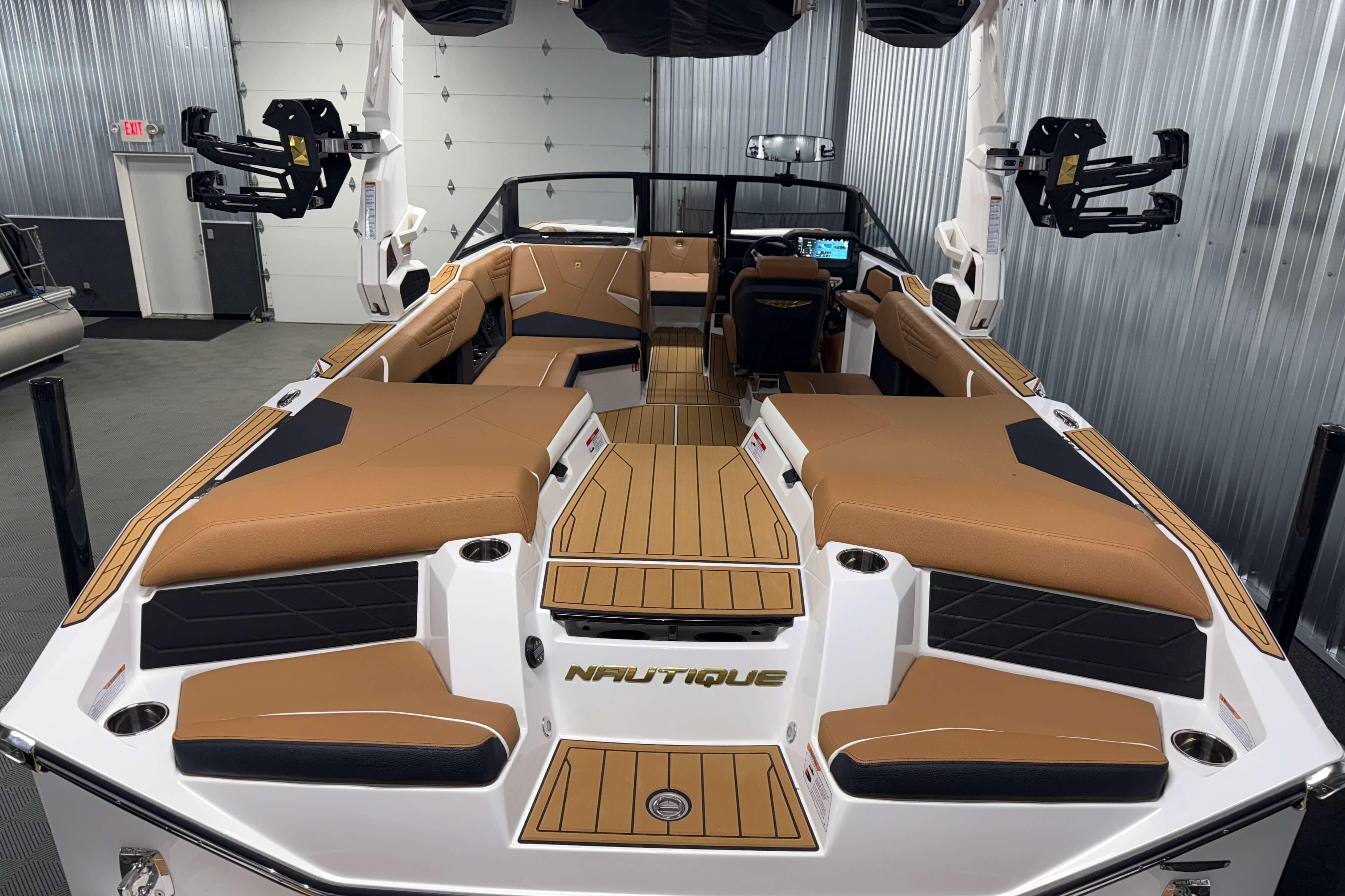 2026 Nautique Super Air Nautique S23 boat interior with tan seating and modern design.
