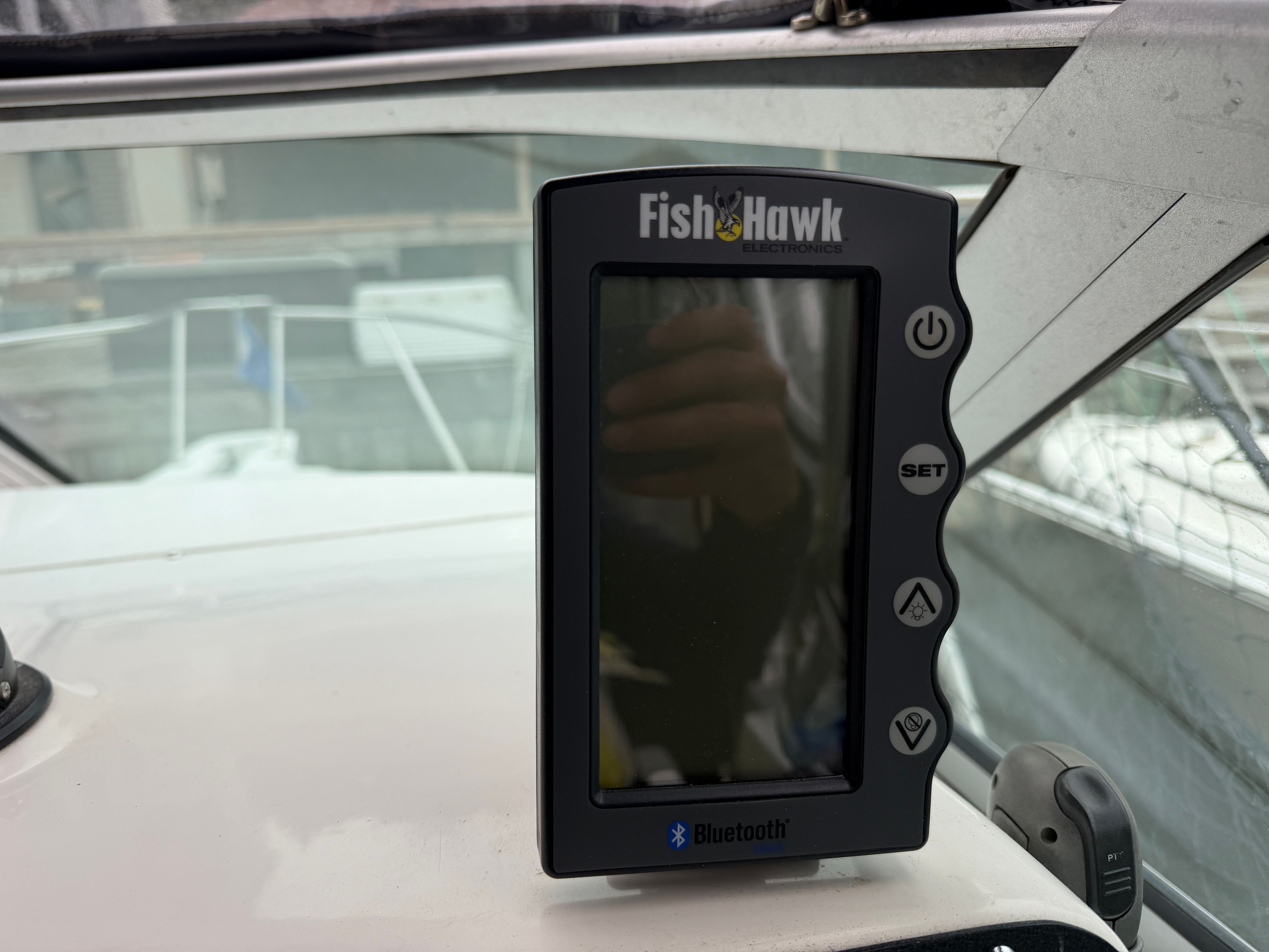 A Fish Hawk Bluetooth device on a boat.