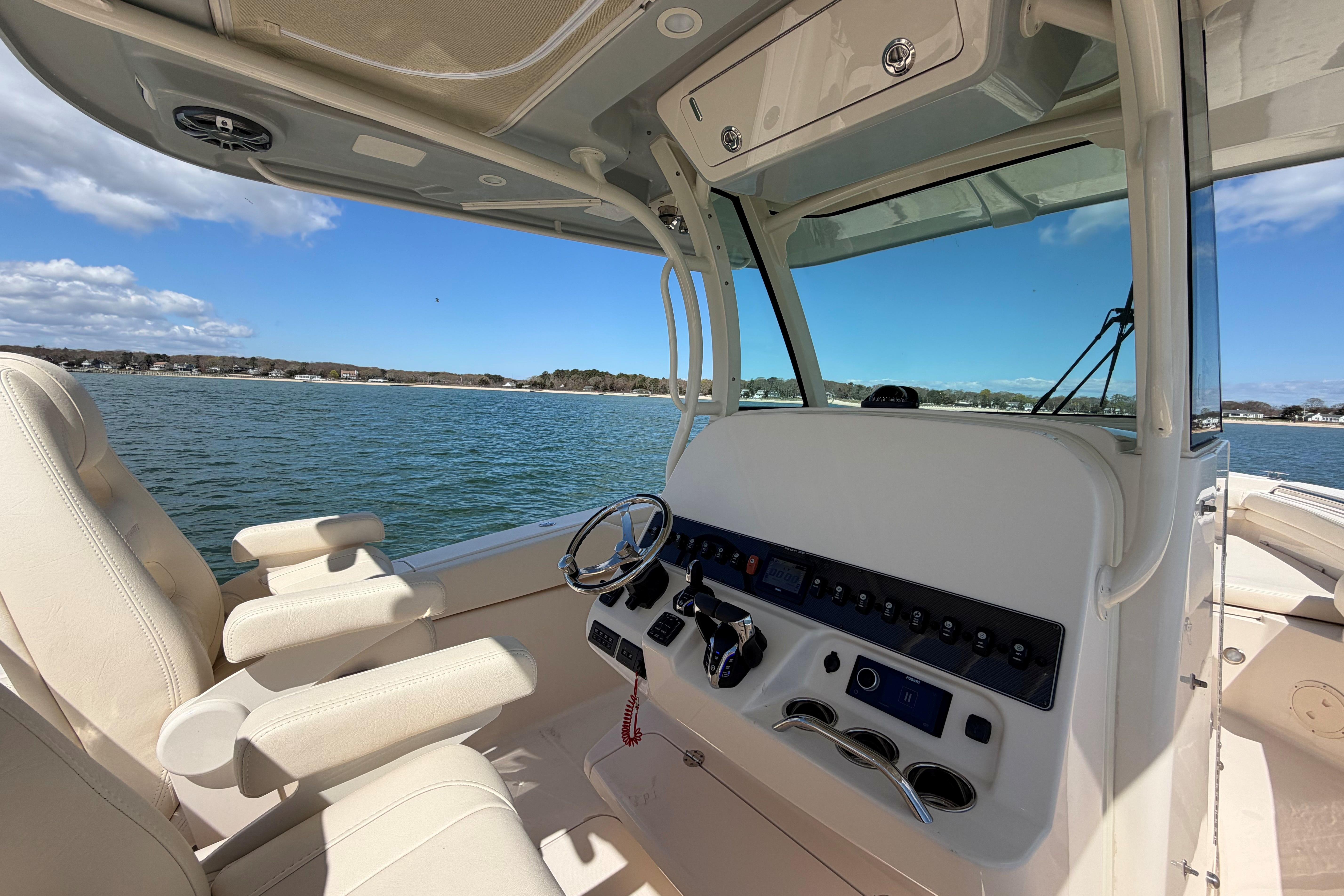 2025 Grady-White Canyon 306 boat interior with steering wheel and control panel.