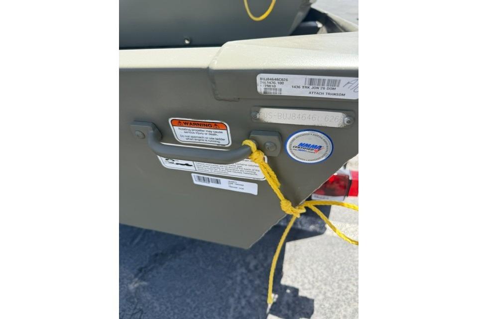 2026 Tracker Grizzly 14 Jon boat with warning labels and yellow rope detail.
