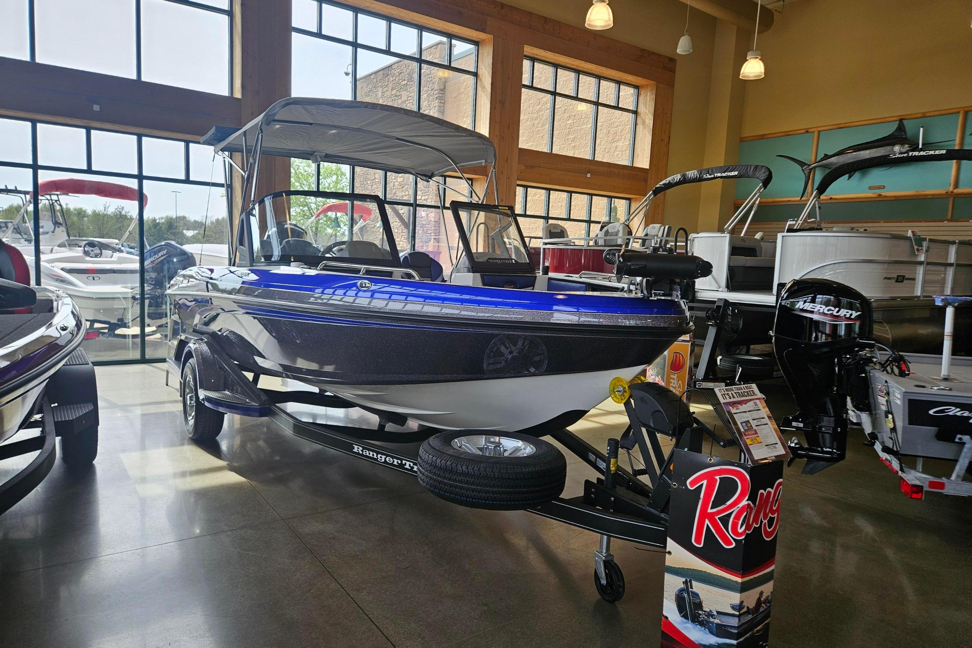 2026 Ranger 1850MS boat displayed in a showroom with large windows.