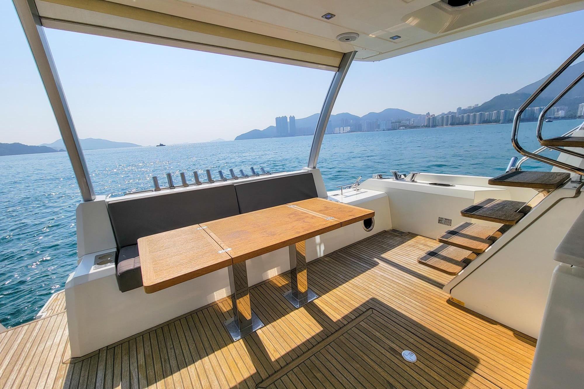 Luxurious 2019 Prestige 630 yacht deck with scenic ocean view and modern seating area.