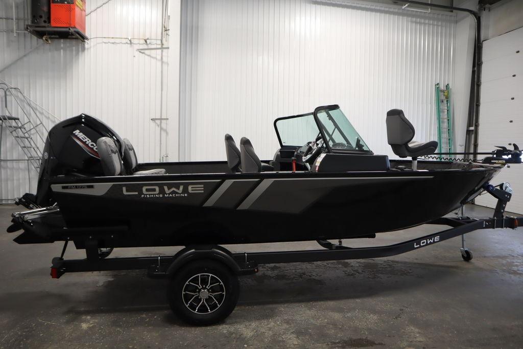 2026 Lowe Fishing Machine 175 boat in a garage, side view.