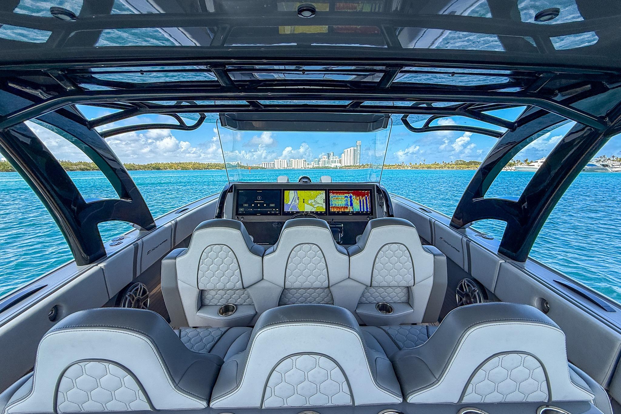 Interior view of 2023 Midnight Express 43 Solstice boat with luxurious seating and navigation screens.