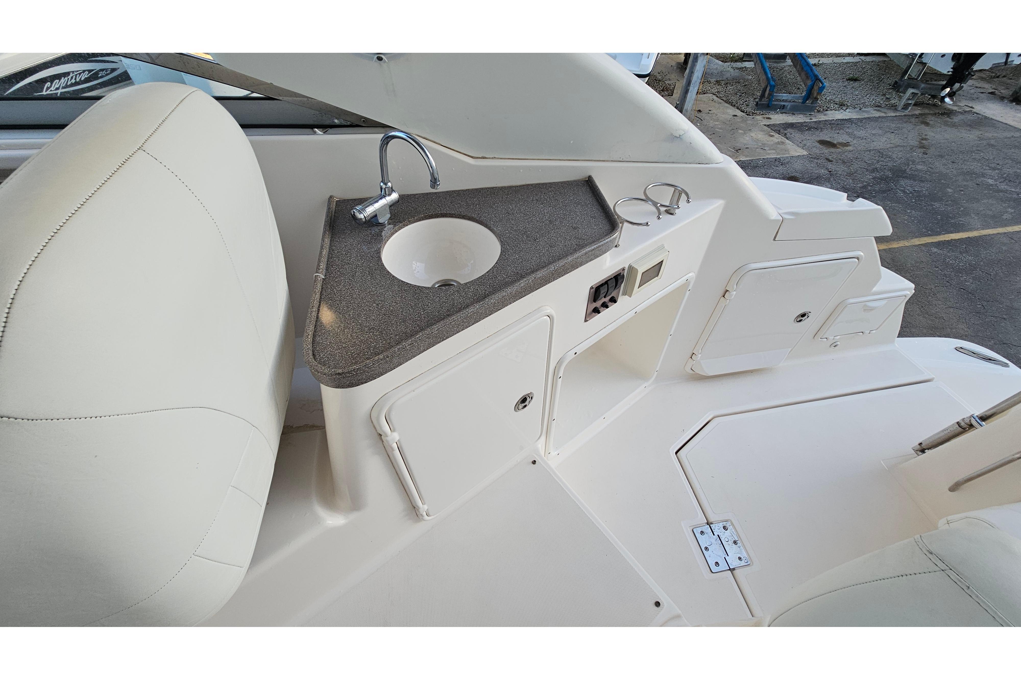 2005 Regal 3060 Window Express boat interior with sink and storage area.
