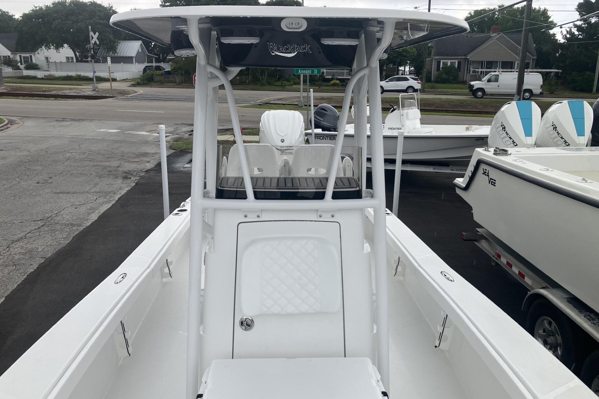 2026 BlackJack 256 Coastal boat, white exterior, parked on a trailer in a lot.
