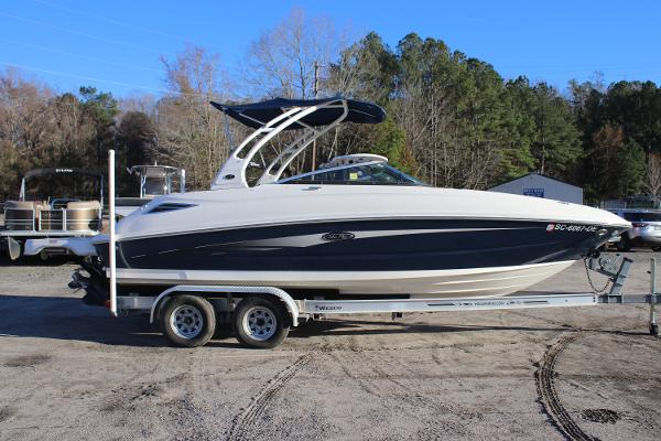 2016 Sea Ray 240 Sundeck boat on trailer, parked outdoors.