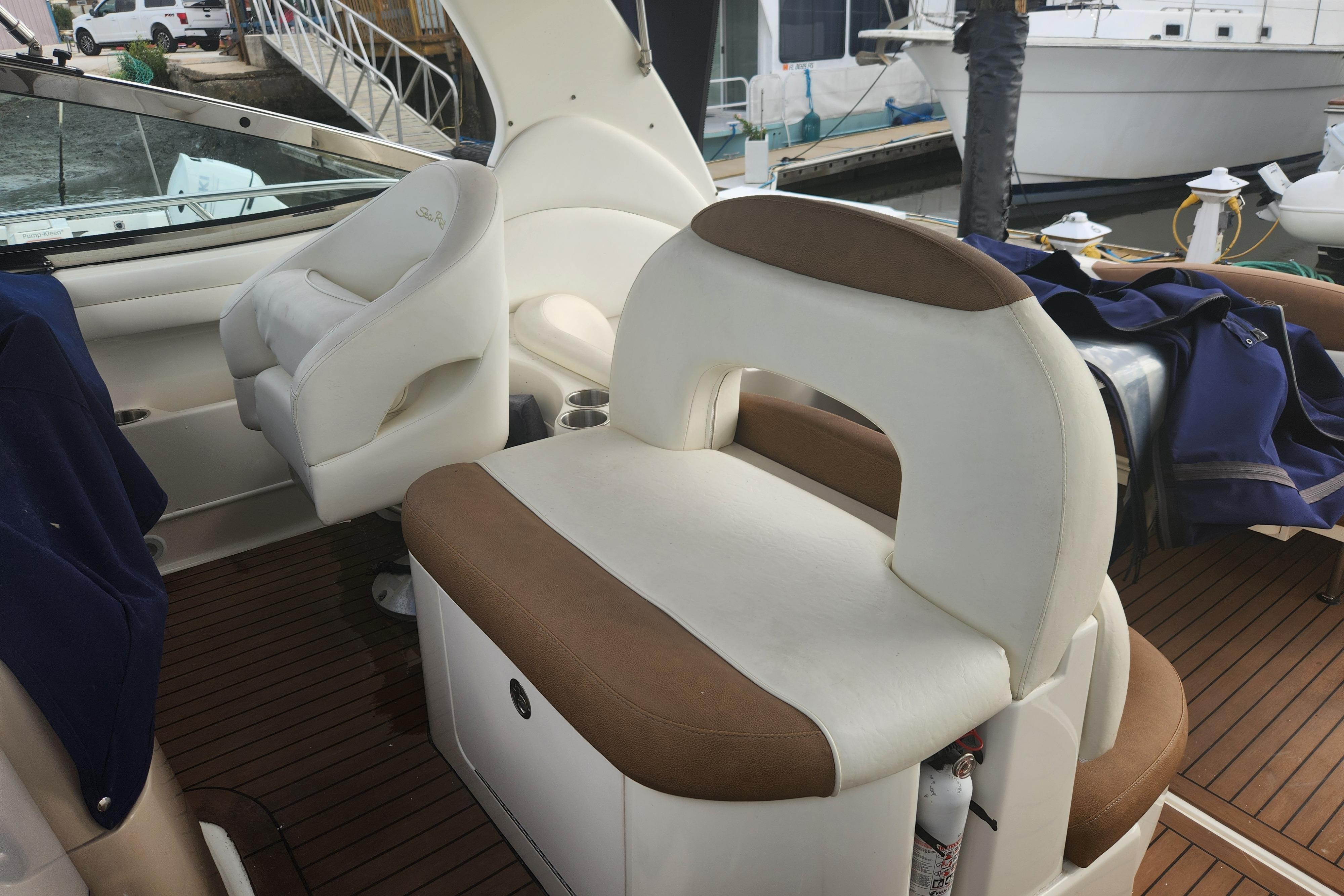 Interior of a 2003 Sea Ray 360 Sundancer boat with white and brown seating.