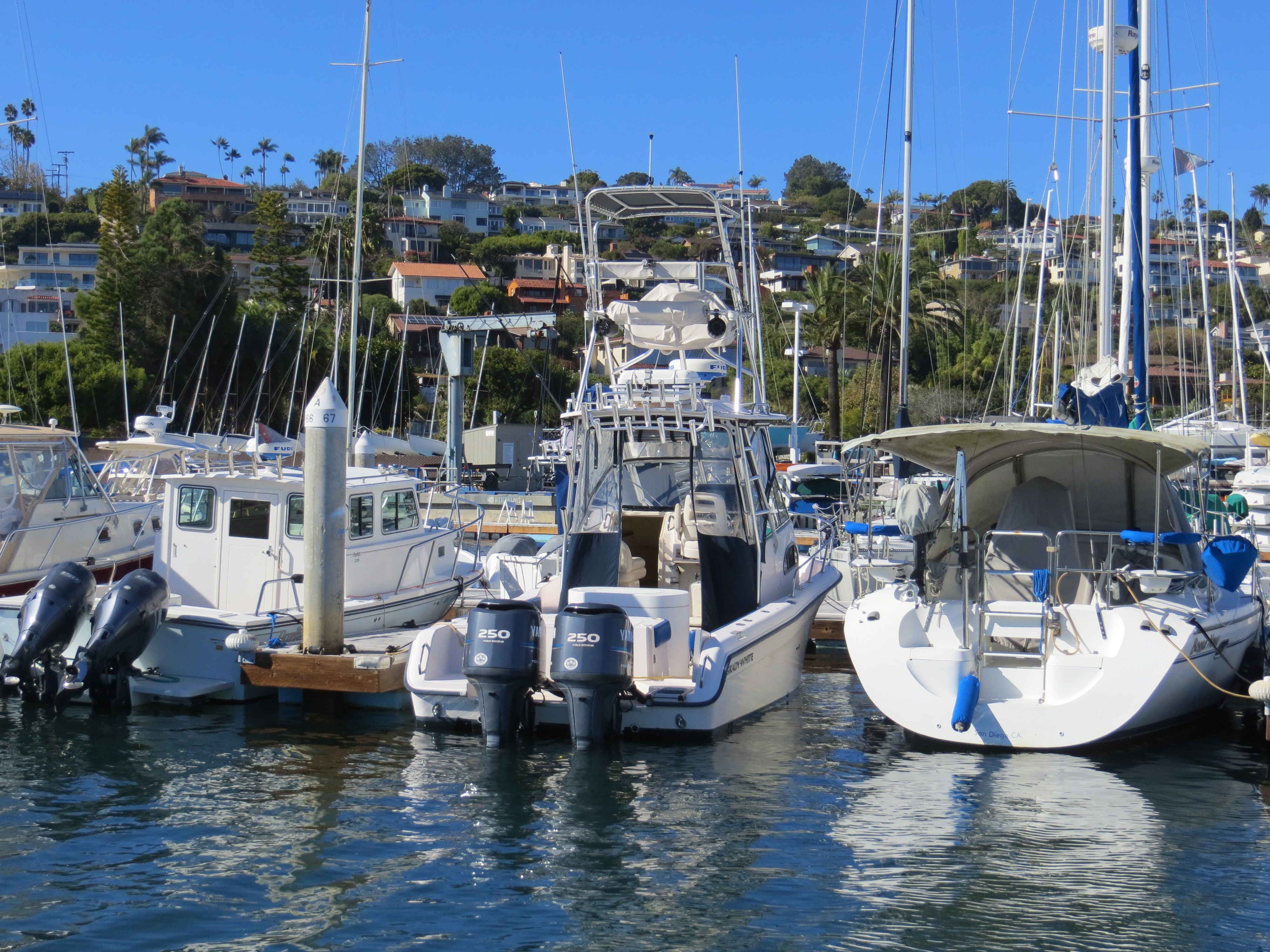 A 2007 Grady-White Sailfish 282 docked in a marina, surrounded by other boats.