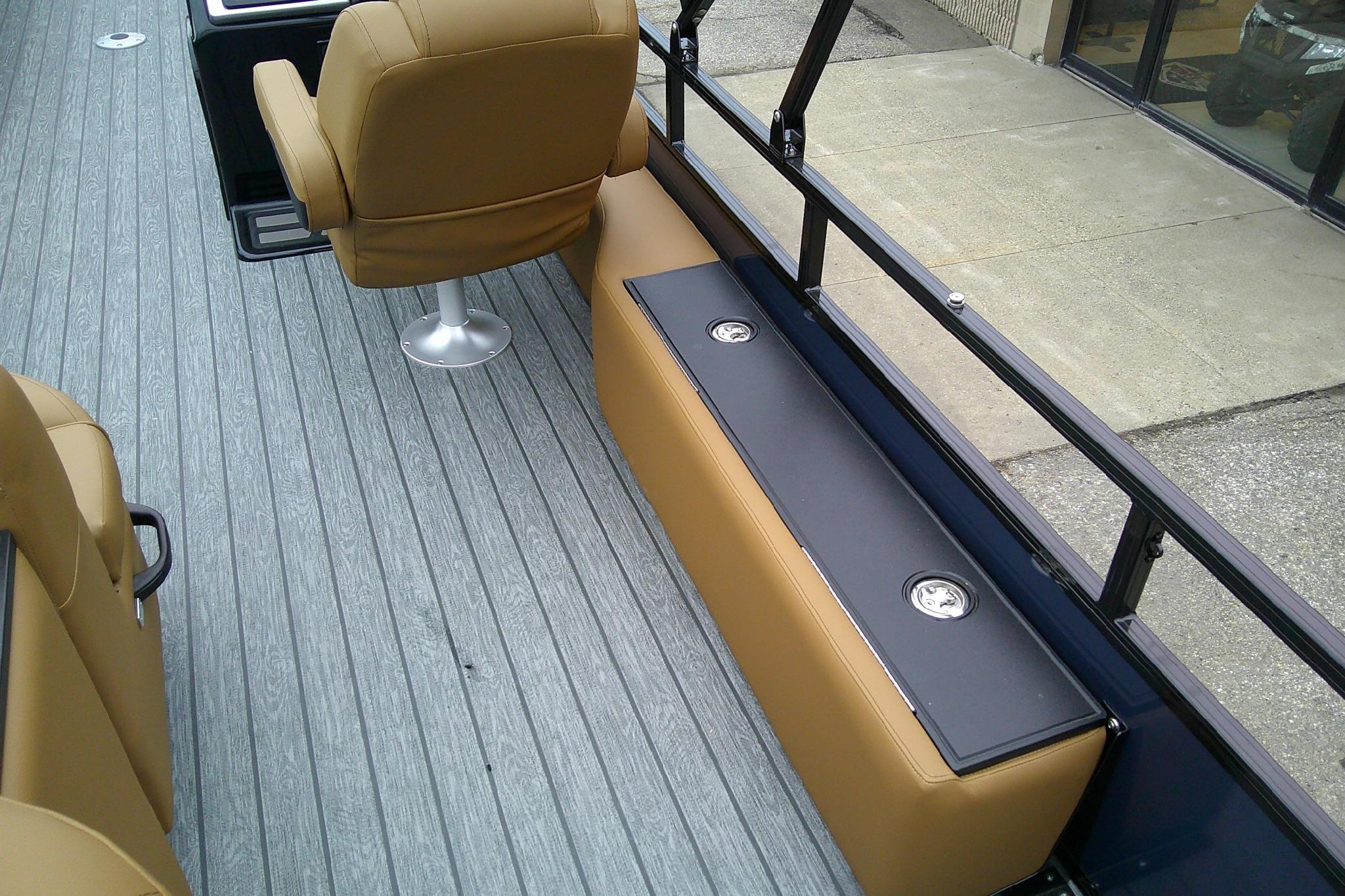 2026 Ranger 220FC boat interior with tan seats and gray flooring.