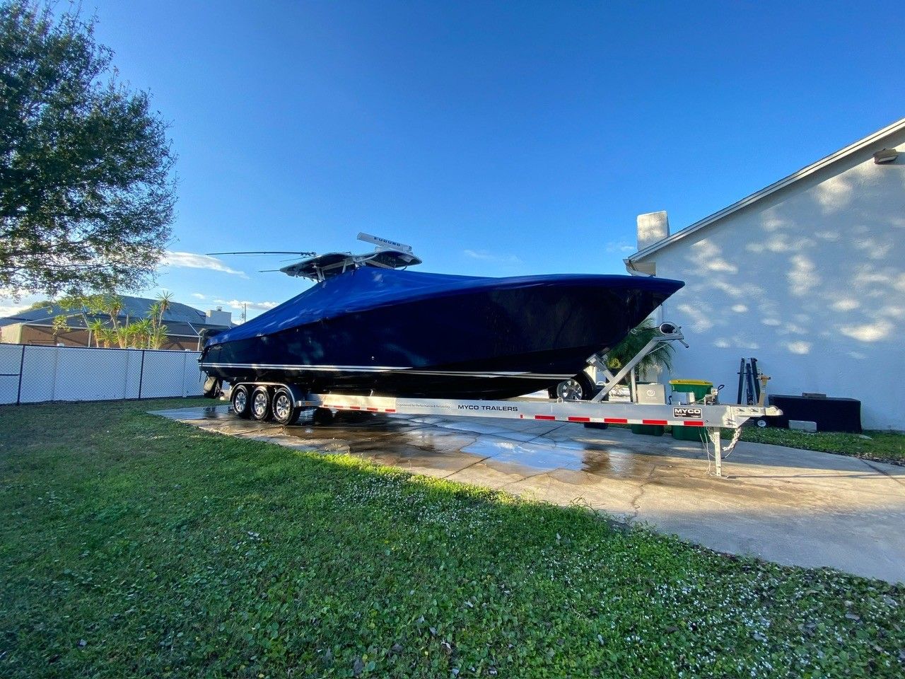 2010 Invincible 36 boat on trailer parked outdoors.