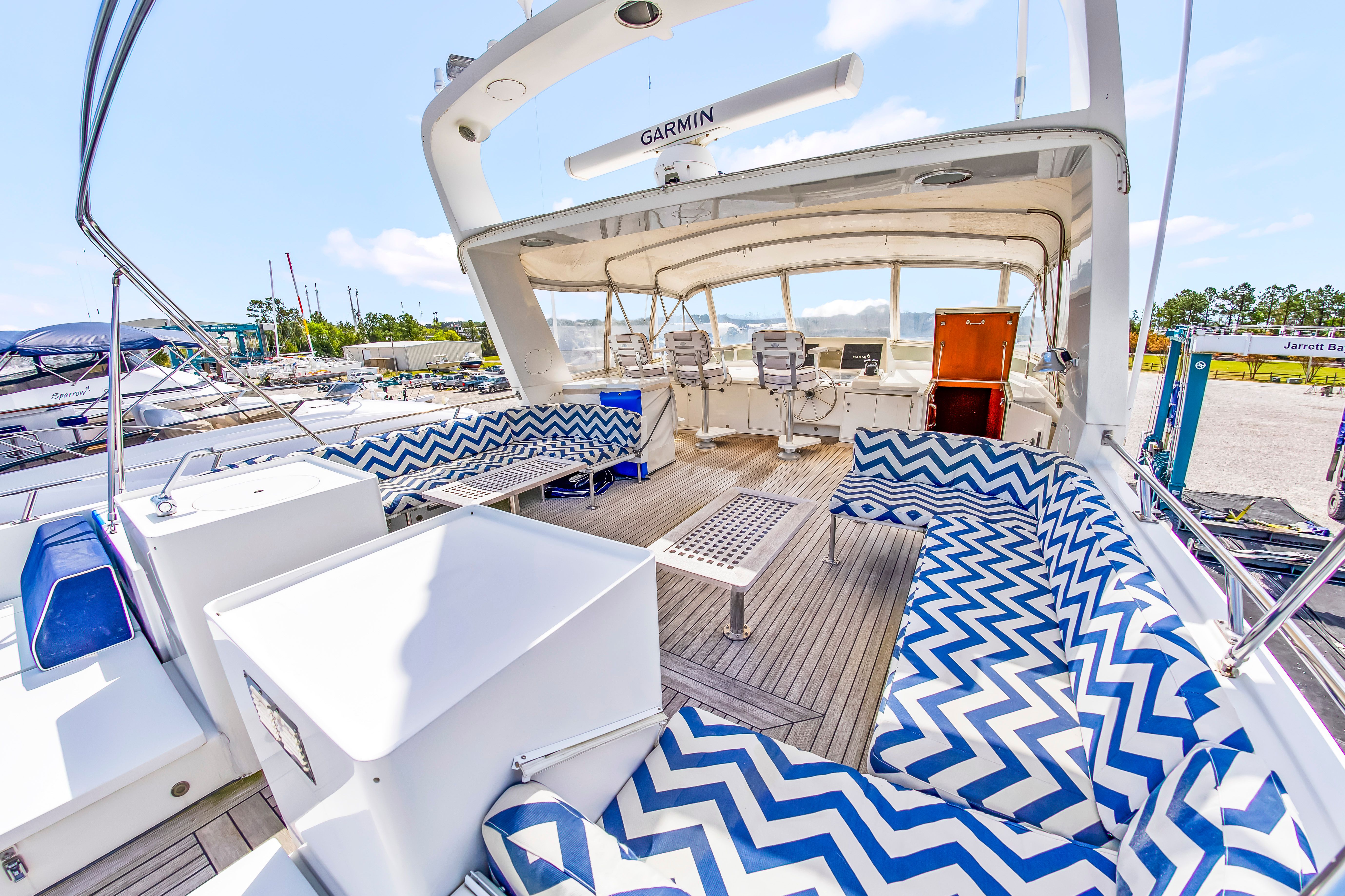 1987 Jongert 78 Motor Yacht with spacious deck and blue-white zigzag patterned seat cushions.