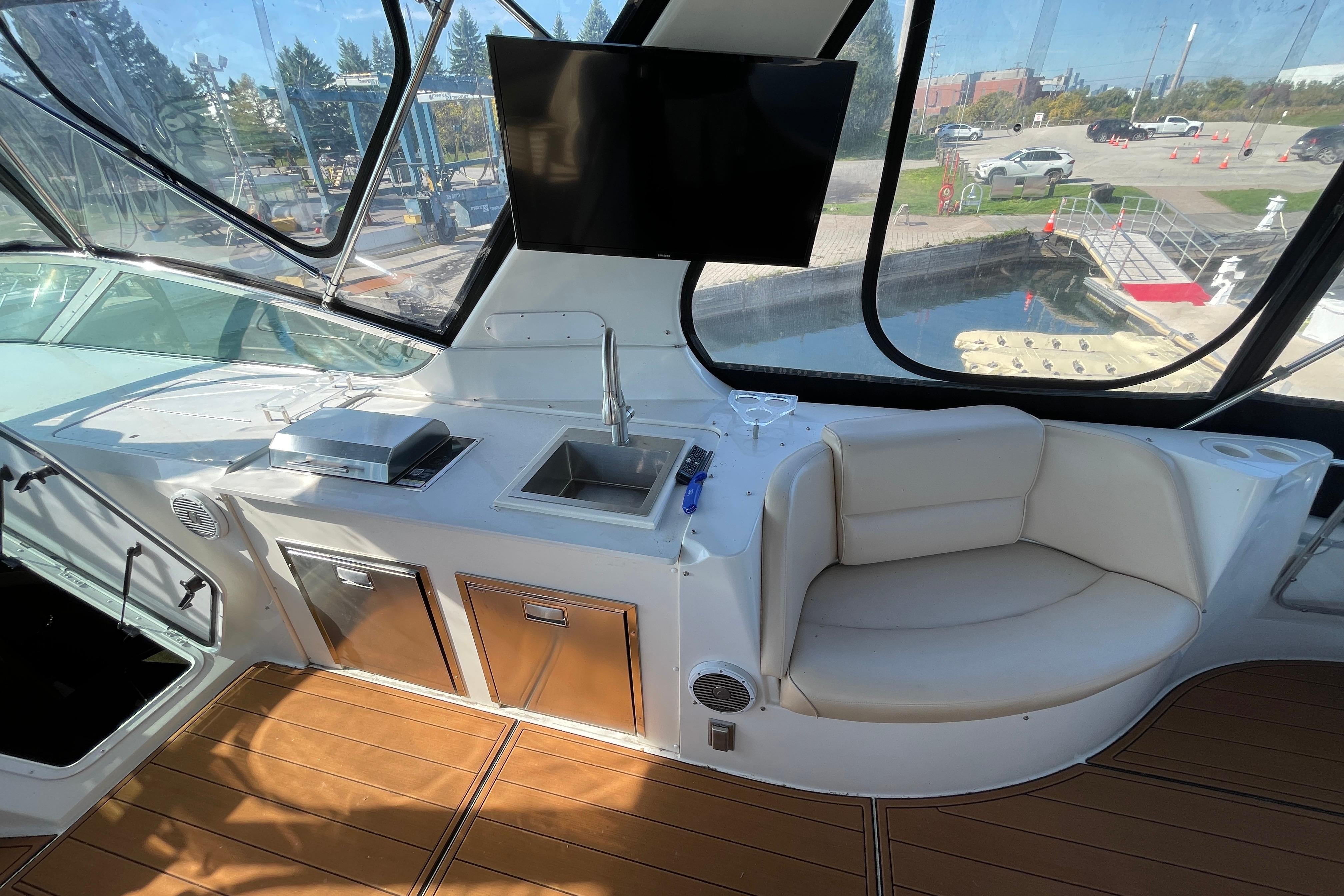 Luxurious interior of 2002 Carver 570 Voyager Pilothouse with seating, sink, and TV.