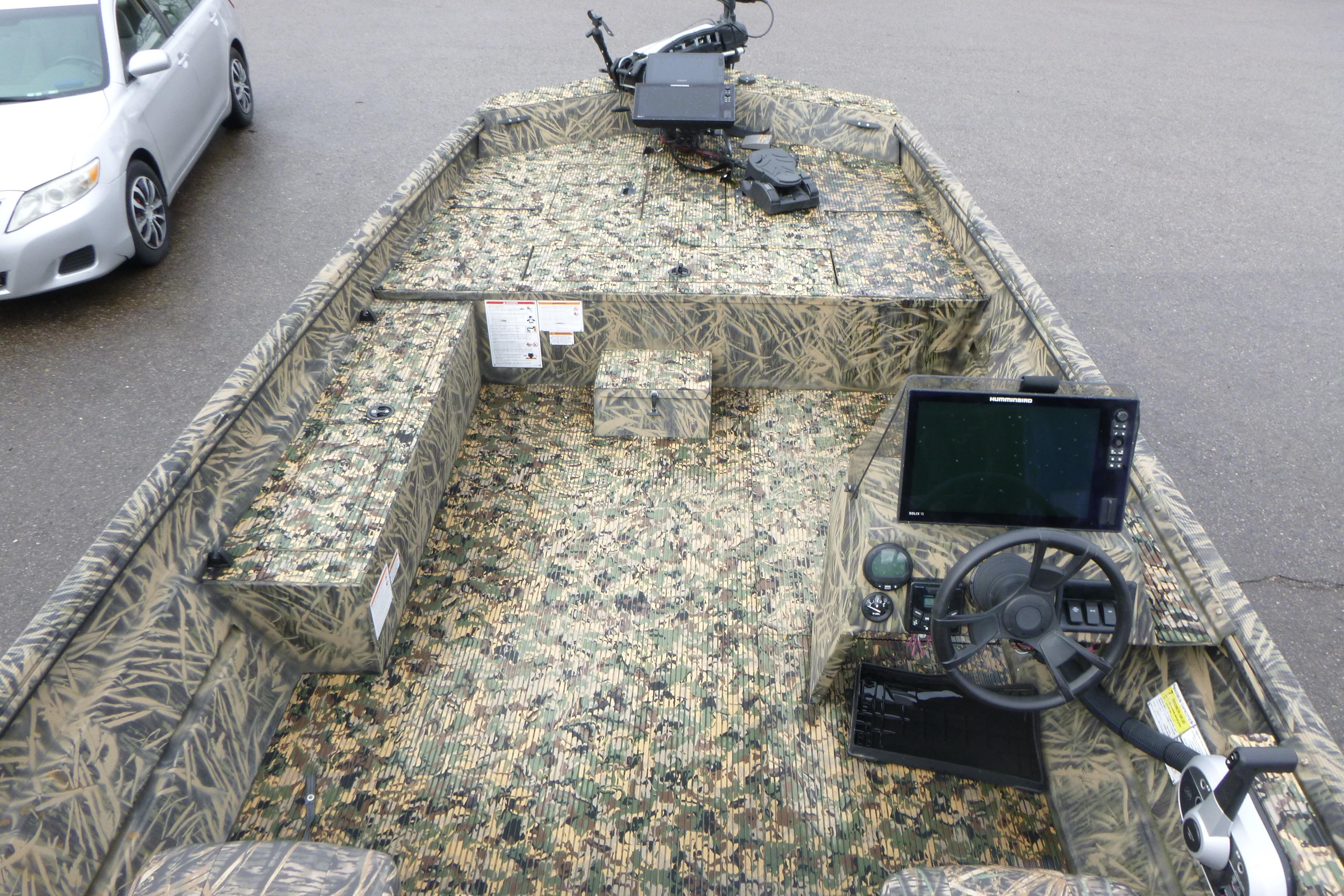 2024 Lowe Roughneck 2070 boat interior with camouflage design and advanced navigation equipment.