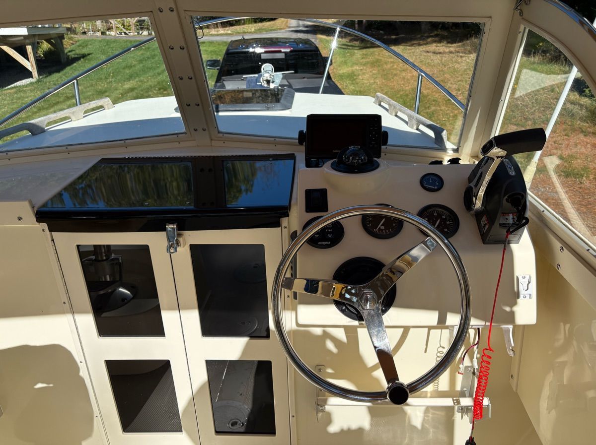 The image shows the helm of a 2018 Seaway Seafarer 21 with a steering wheel and instruments.