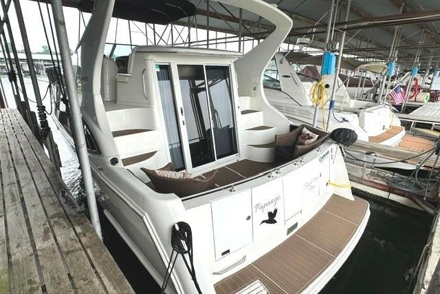 2004 Carver 360 Mariner docked, featuring spacious deck and sliding glass doors.