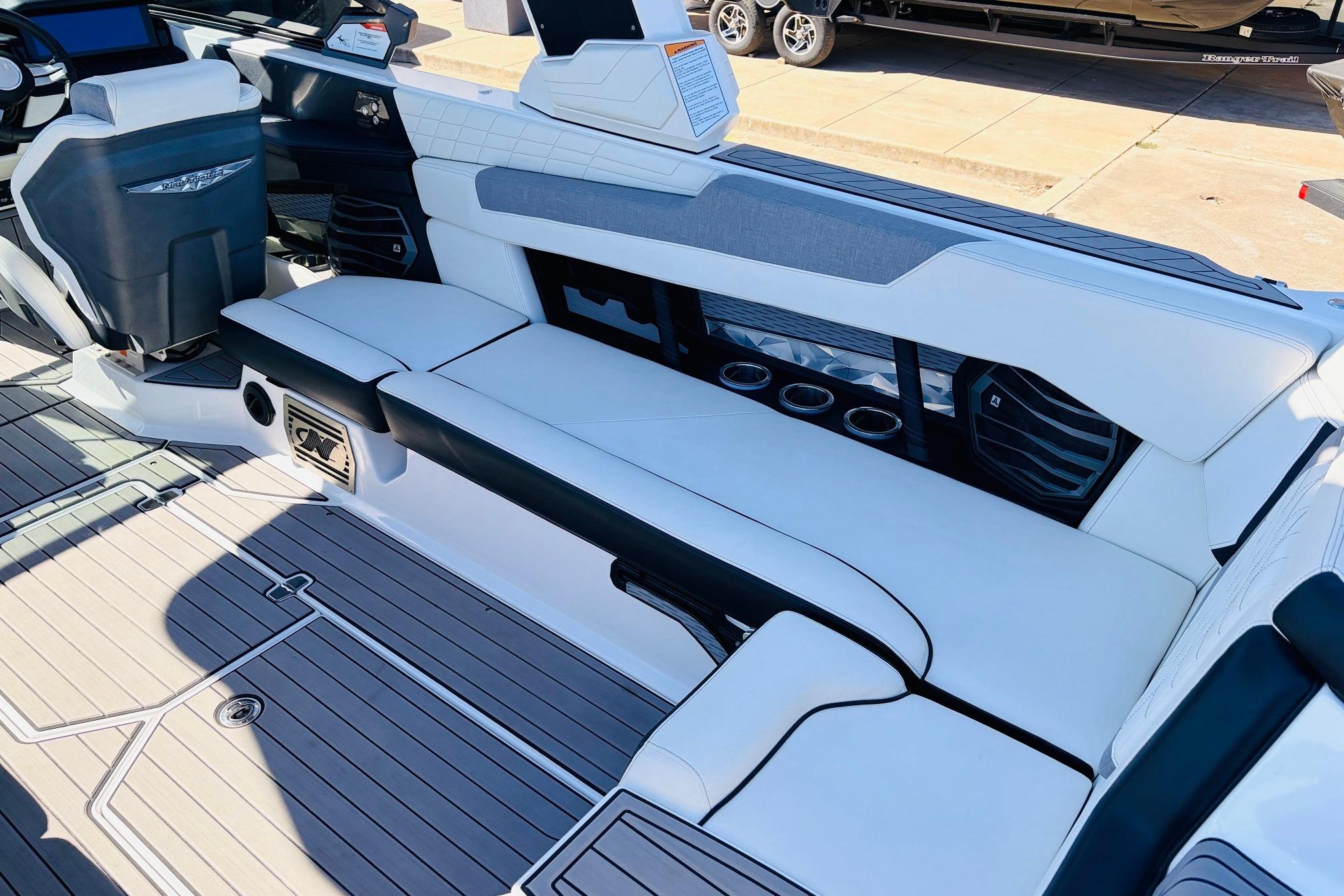 2023 Nautique Super Air Nautique G25 interior with white seating and modern dashboard.
