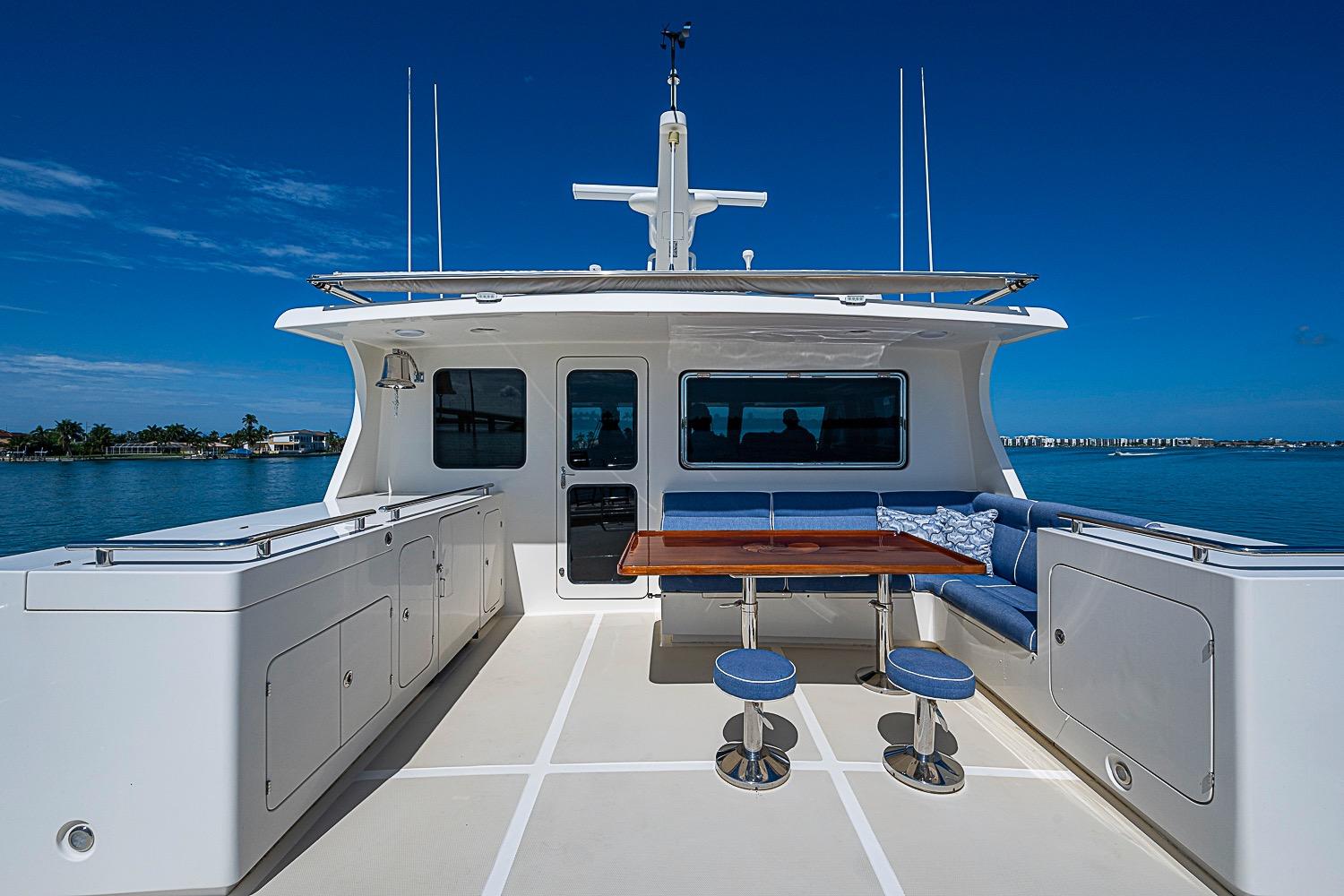 Luxurious 2014 Marlow 80 Explorer yacht deck with seating and ocean view.