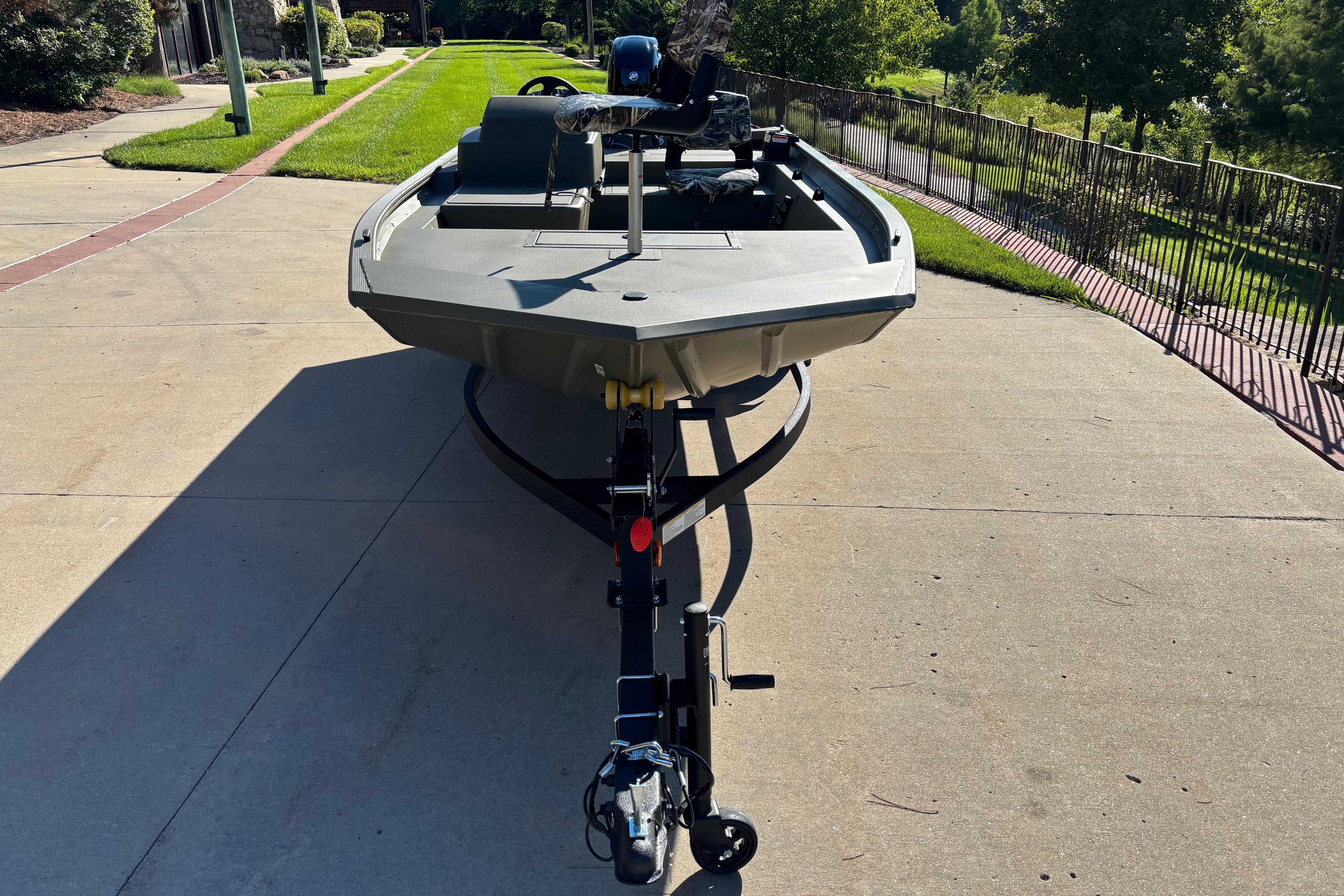 2026 Tracker Grizzly 1754 SC boat on trailer, parked on a sunny driveway.