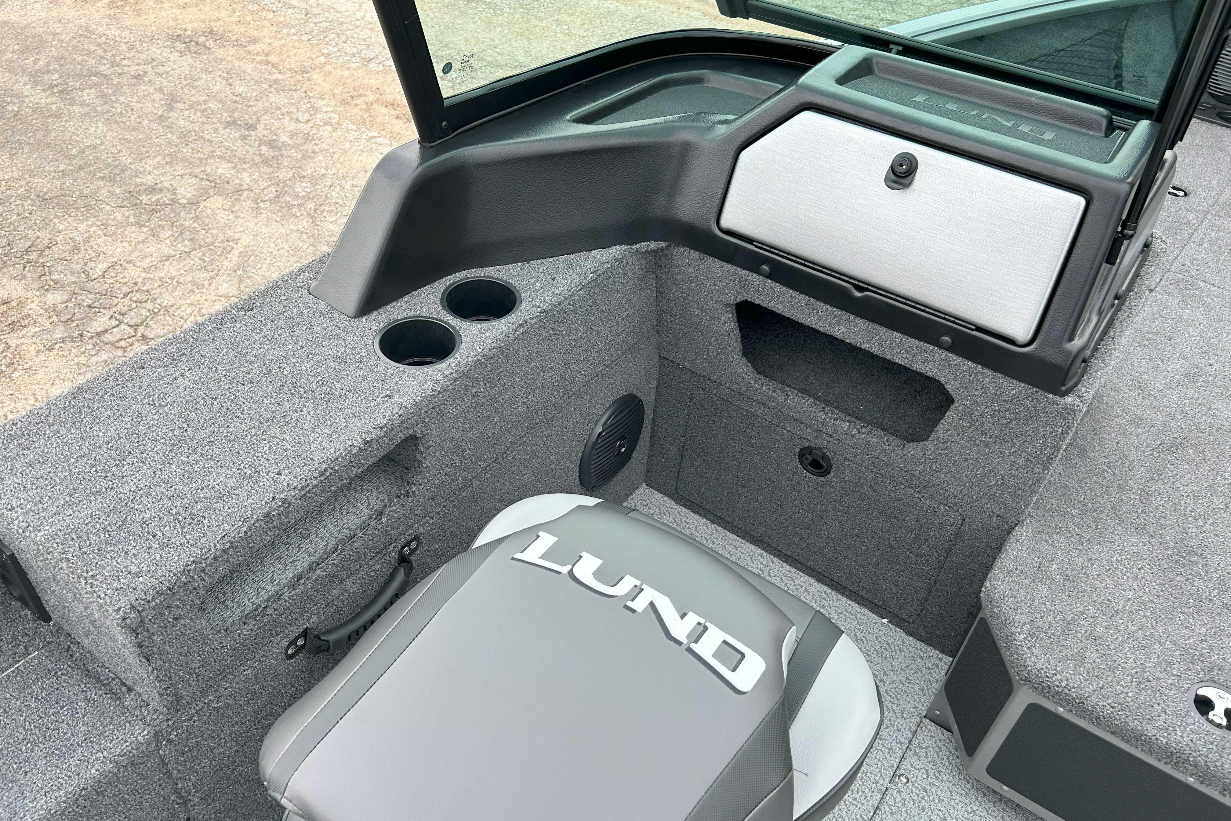 Interior of 2026 Lund 1875 Impact XS Sport boat with seating and storage compartments.