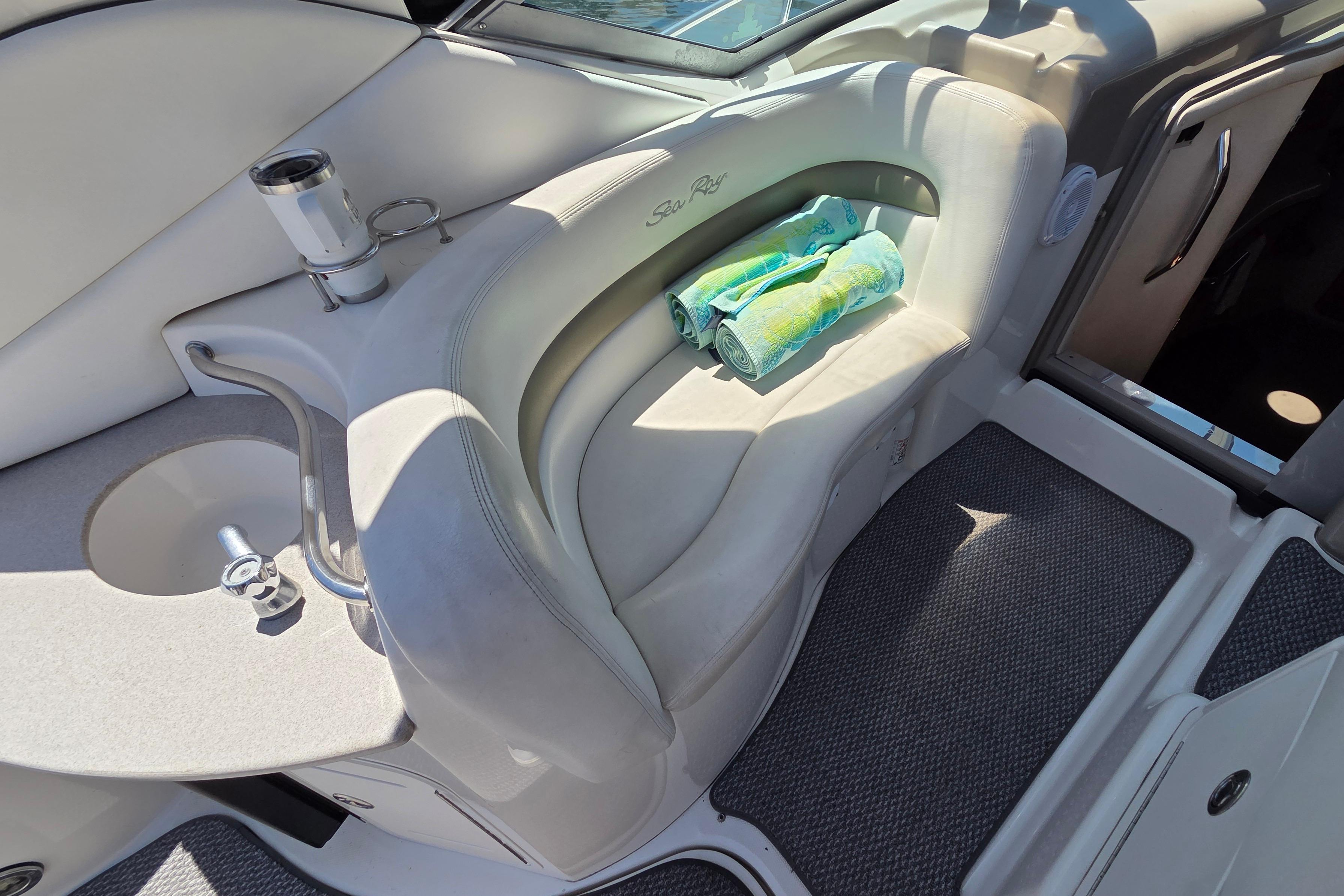 Interior of 2006 Sea Ray Sundancer 320 with seating, sink, and towels.