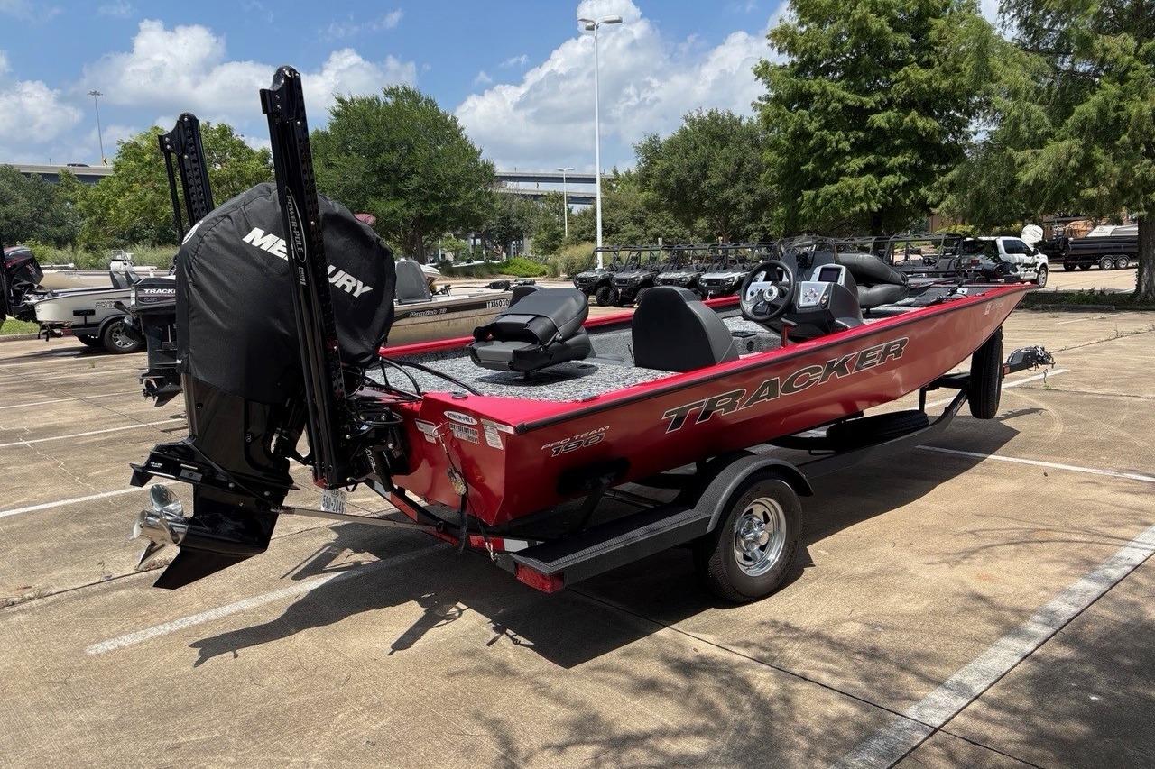 2026 Tracker Pro Team 190 TX boat with Mercury engine in parking lot.