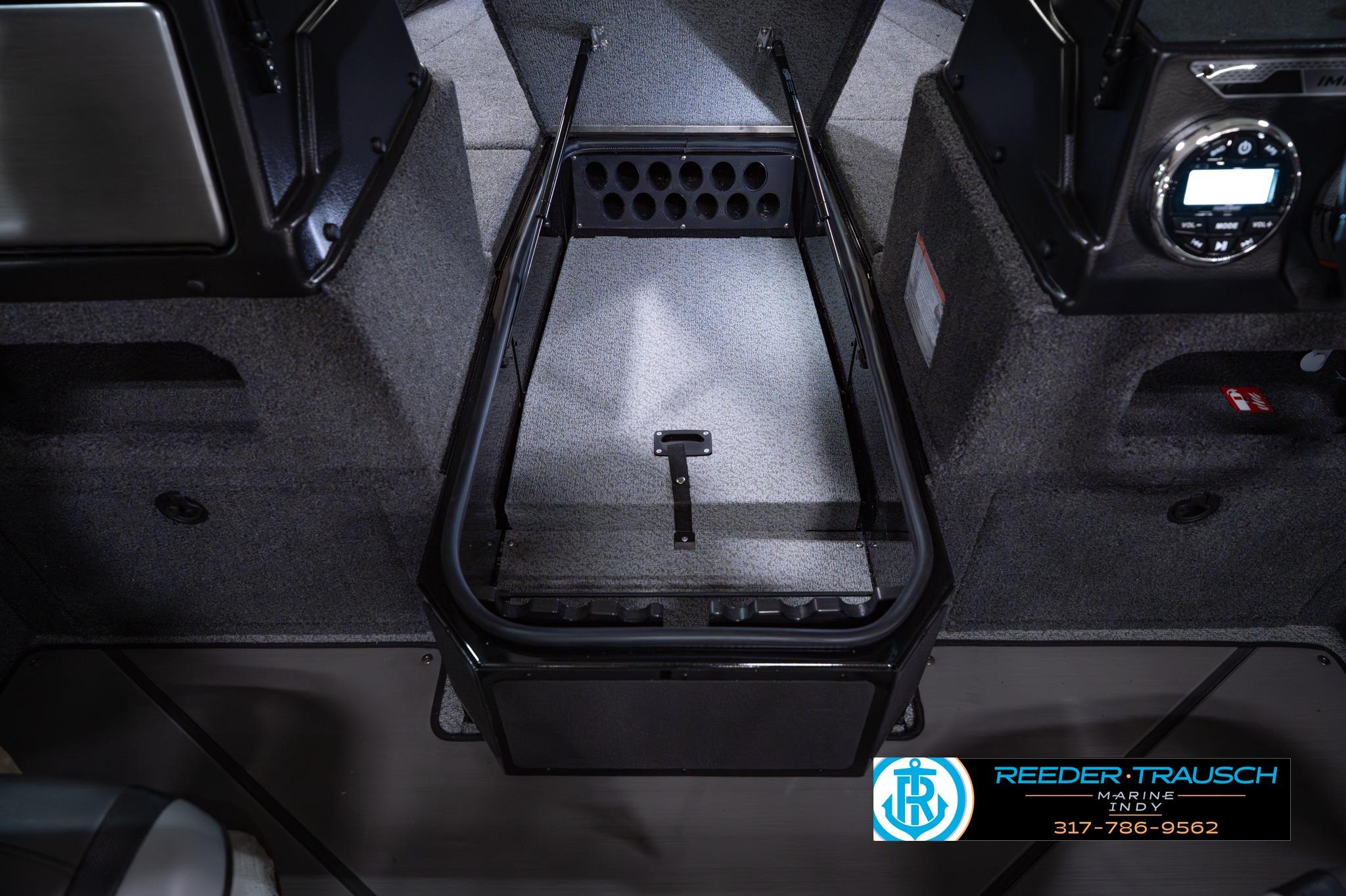 2026 Lund 1875 Impact XS SS boat interior with storage compartment and control panel.
