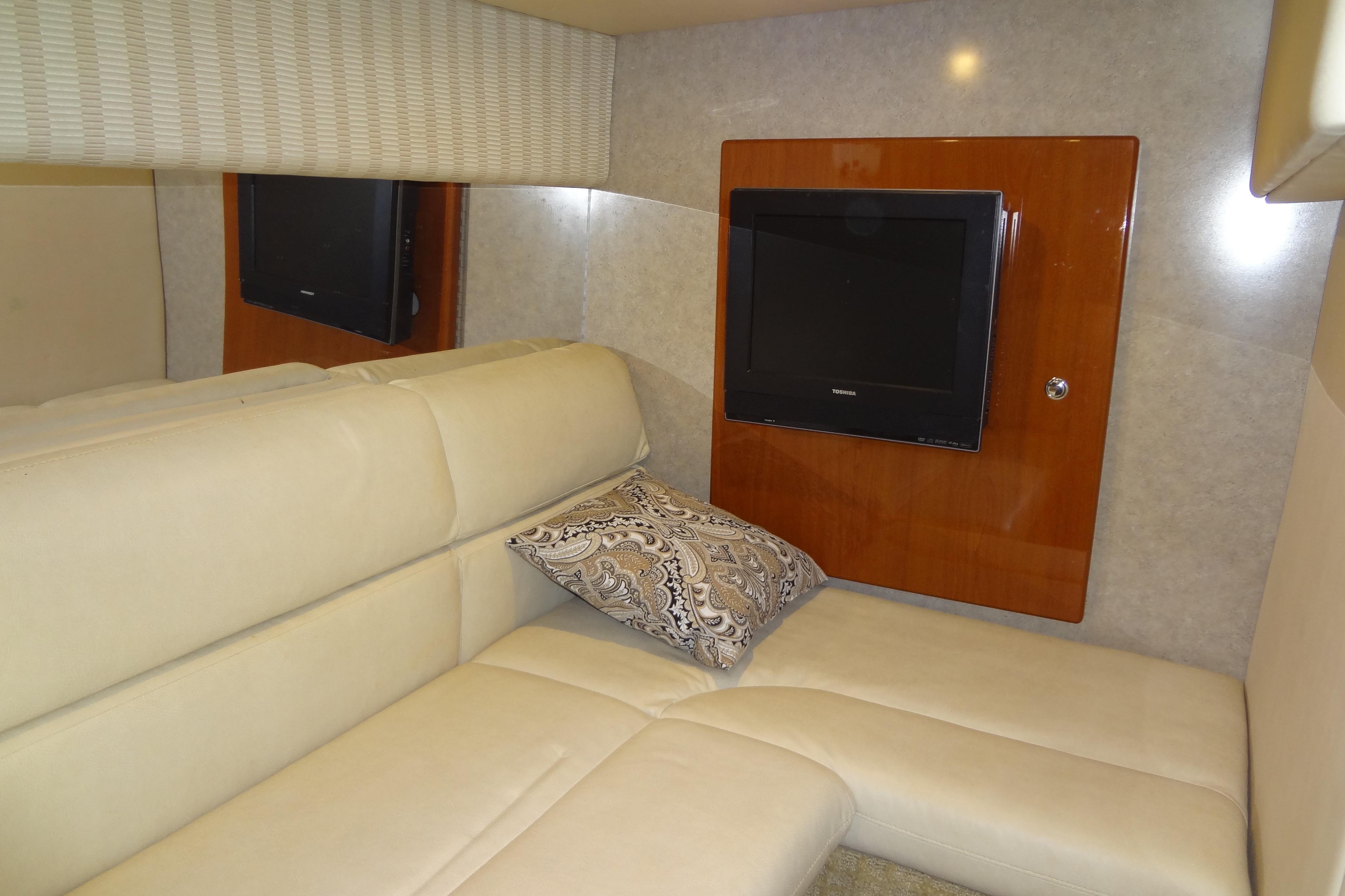 Luxurious interior of 2007 Formula 34 Performance Cruiser with beige seating and wall-mounted TV.