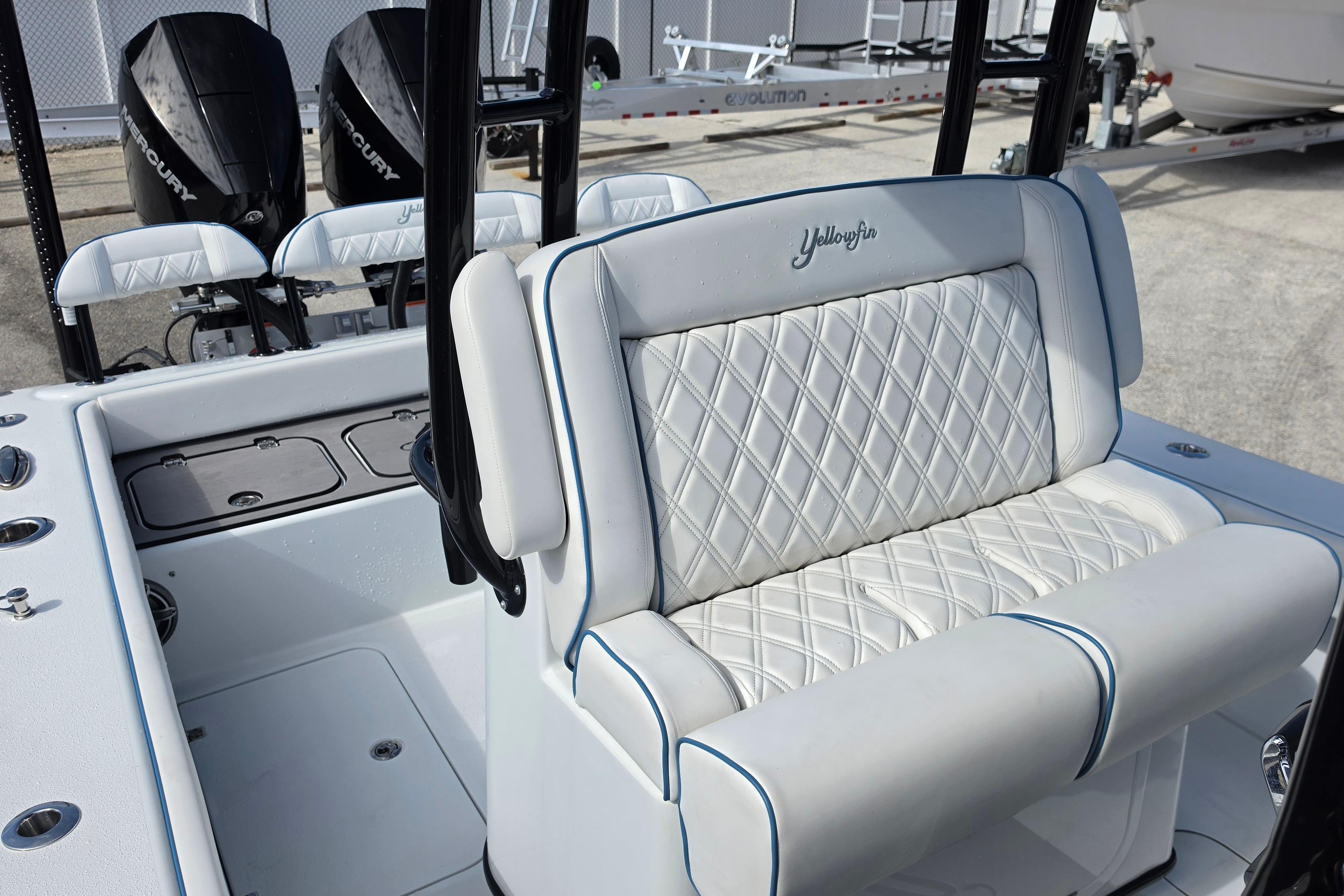2025 Yellowfin 26 Hybrid boat interior with diamond-stitched seating and dual Mercury engines.